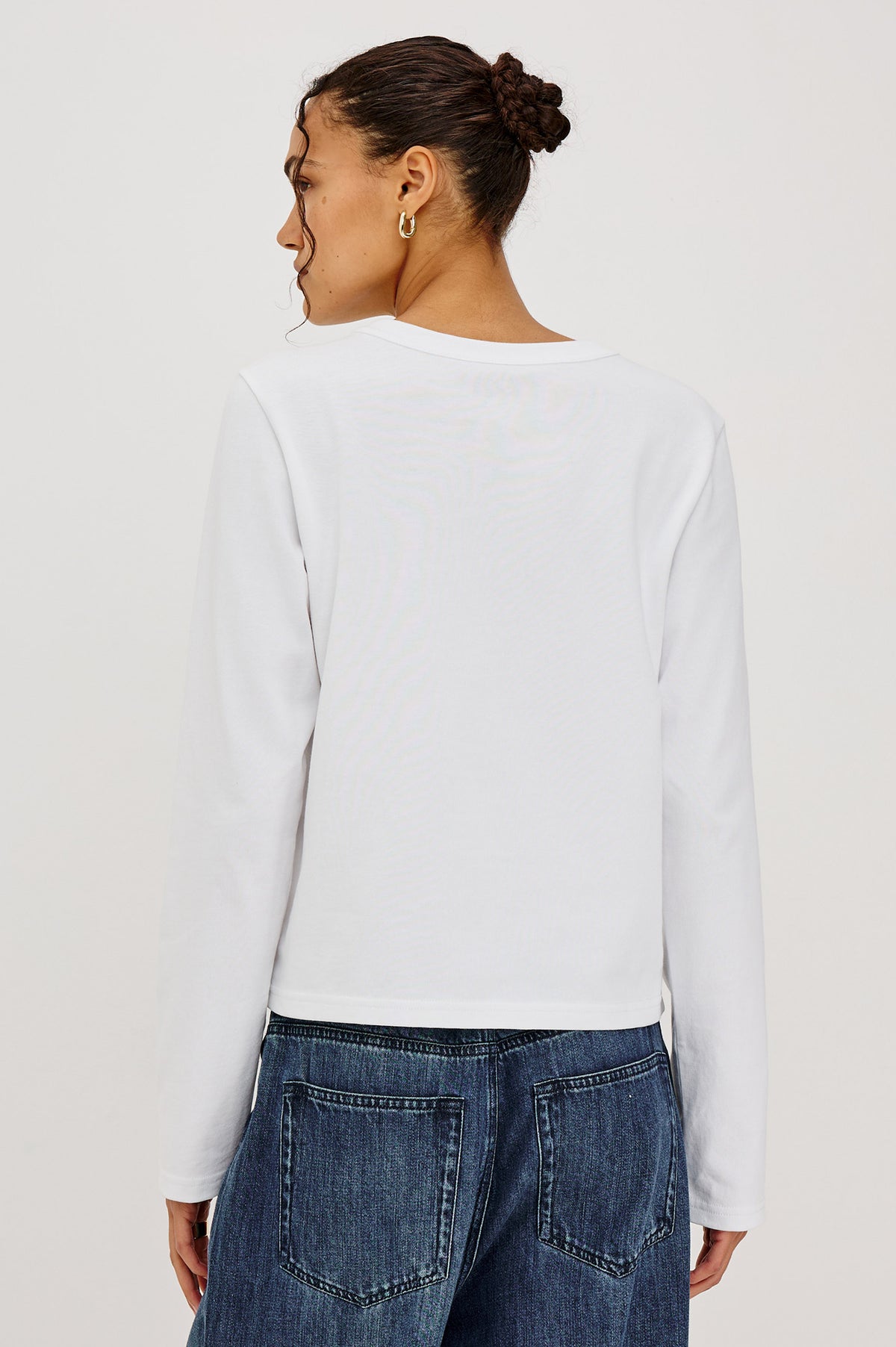 Long Sleeve Girlfriend Tee in Midweight Pleated Jersey in Slightly Boxy Cropped Fit With Crew Neckline in White Colorway - Upper Body Back View Featured on Model.