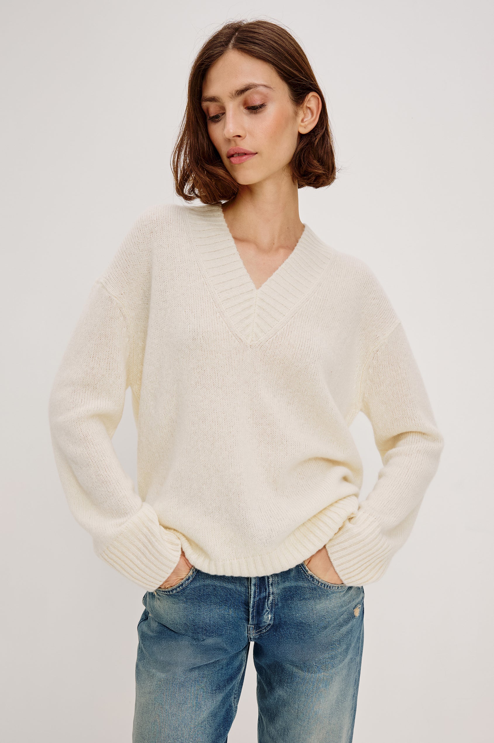 Gisella Long-Sleeve V Neck Sweater with Ribbed Trim and Side Slits in Ivory Colorway - Front View Featured on Model
