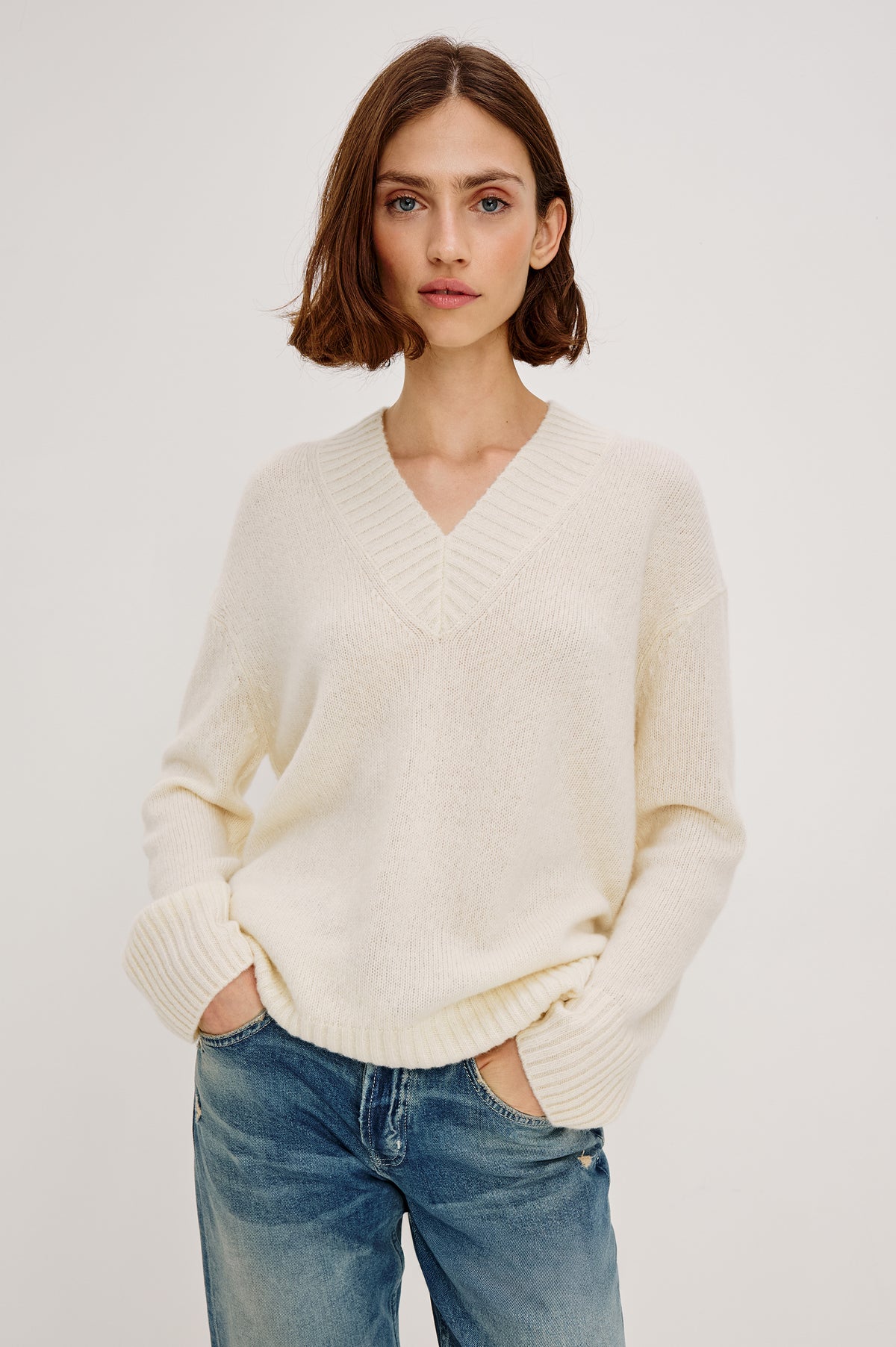 Gisella Long-Sleeve V Neck Sweater with Ribbed Trim and Side Slits in Ivory Colorway - Front View Featured on Model