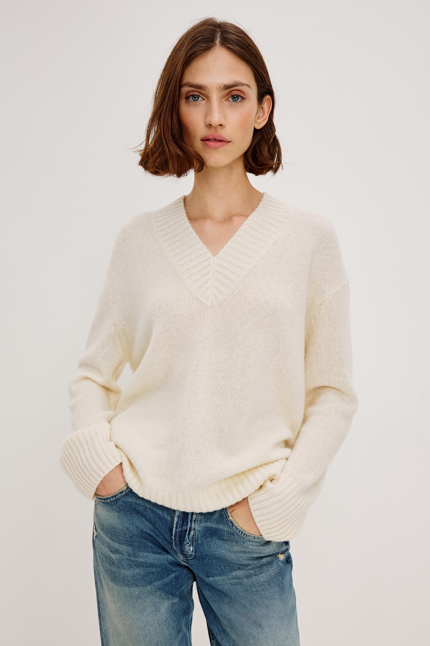 Gisella Long-Sleeve V Neck Sweater with Ribbed Trim and Side Slits in Ivory Colorway - Front View Featured on Model