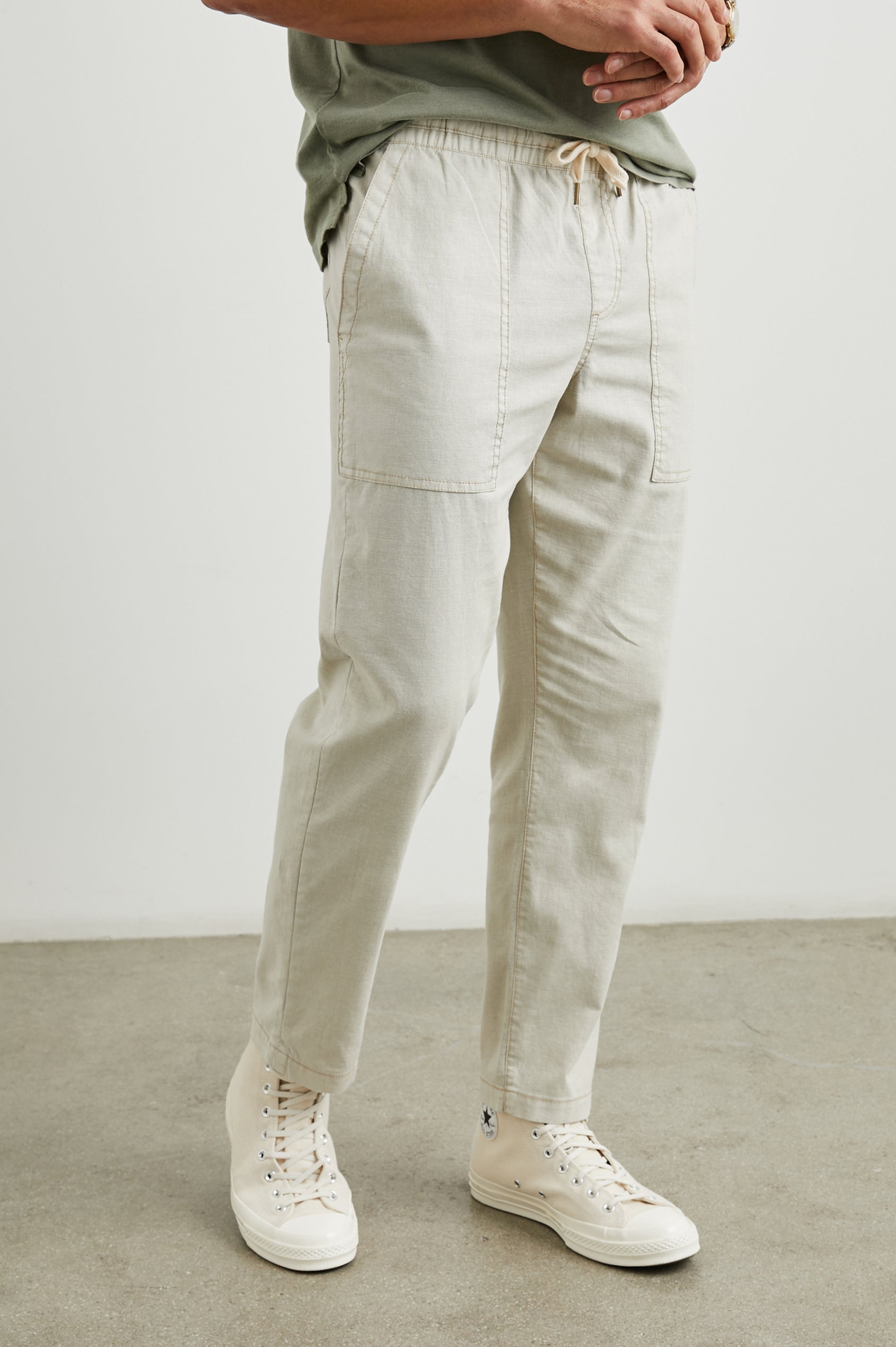 Gobi Pants with Drawstring Waist, Two Large Front Pockets and Two Back Buttoned Patch Pockets in Natural Colorway - Front View Featured on Model