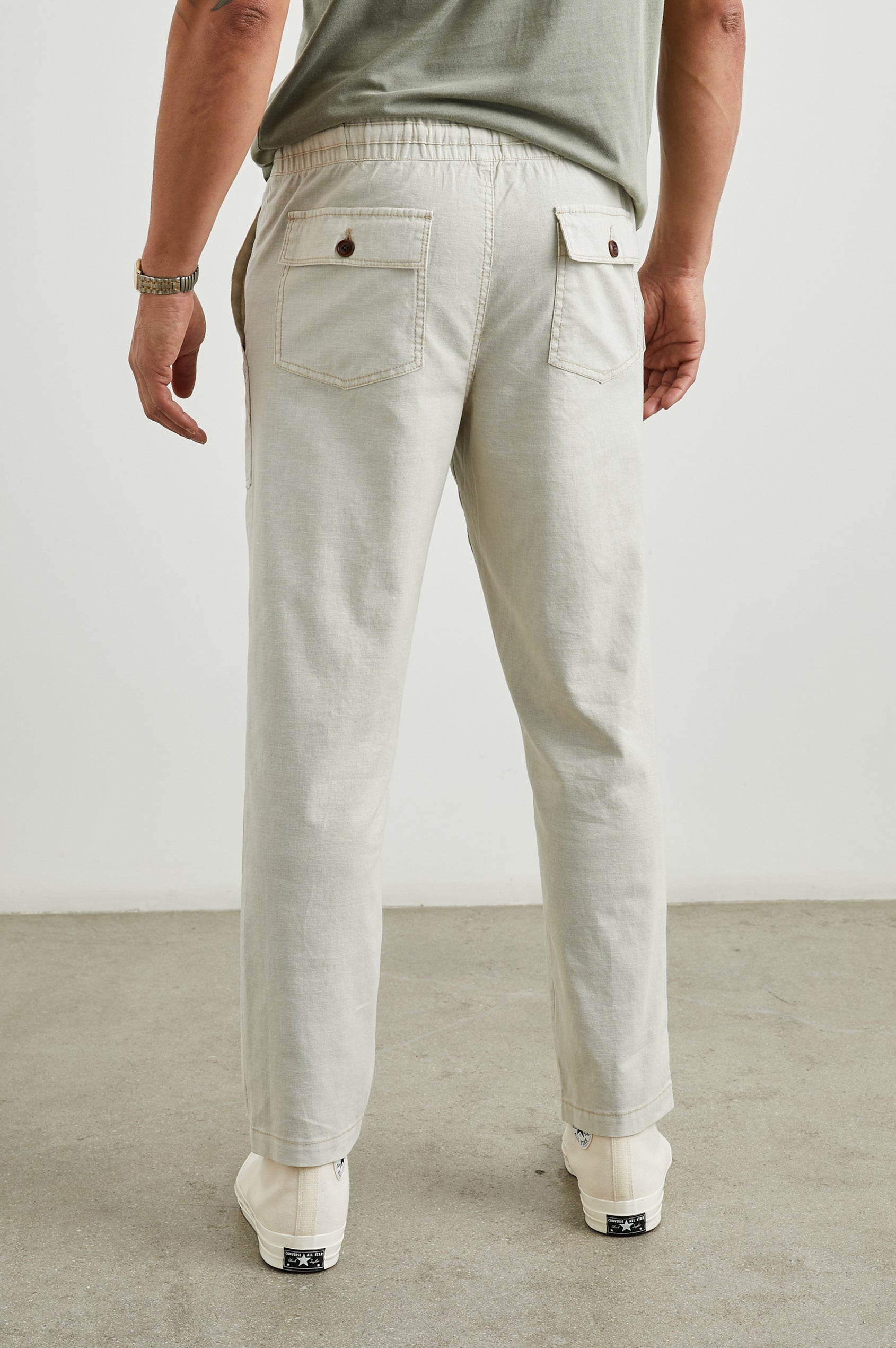 Gobi Pants with Drawstring Waist, Two Large Front Pockets and Two Back Buttoned Patch Pockets in Natural Colorway - Back View Featured on Model
