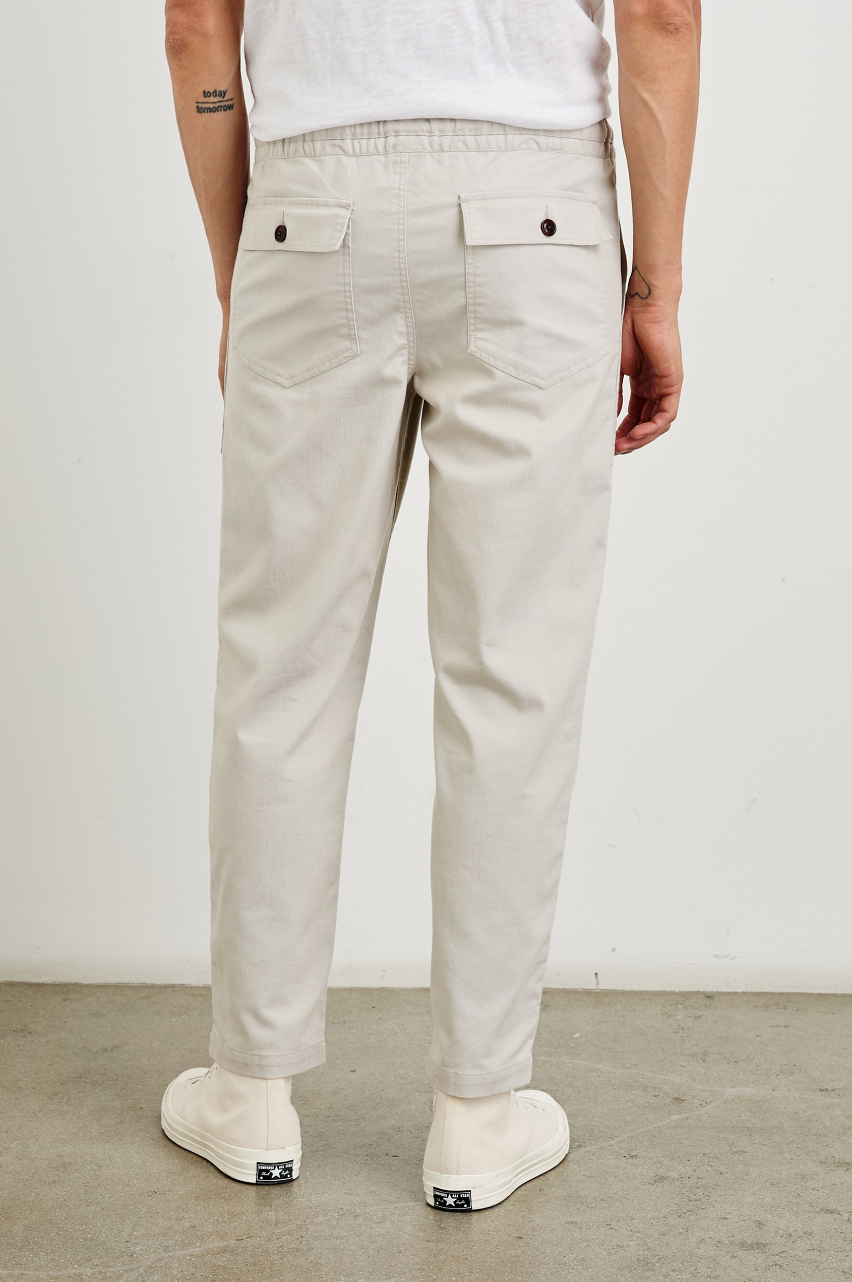 Gobi Pants with Drawstring Waist, Two Large Front Pockets and Two Back Buttoned Patch Pockets in Oat Railroad Dobby Colorway - Back View Featured on Model