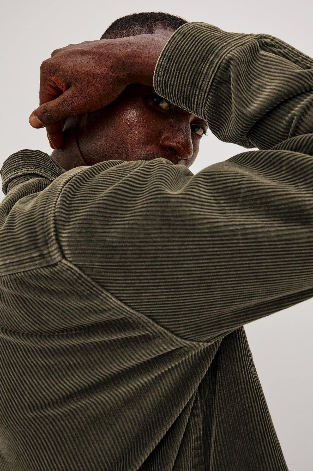 Graham Overshirt in Corduroy With Vintage Wash, Relaxed Fit, Collar, Chest Patch Pocket, and Front Buttons in Lichen Green Colorway - Upper Body Close Up View Featured on Model