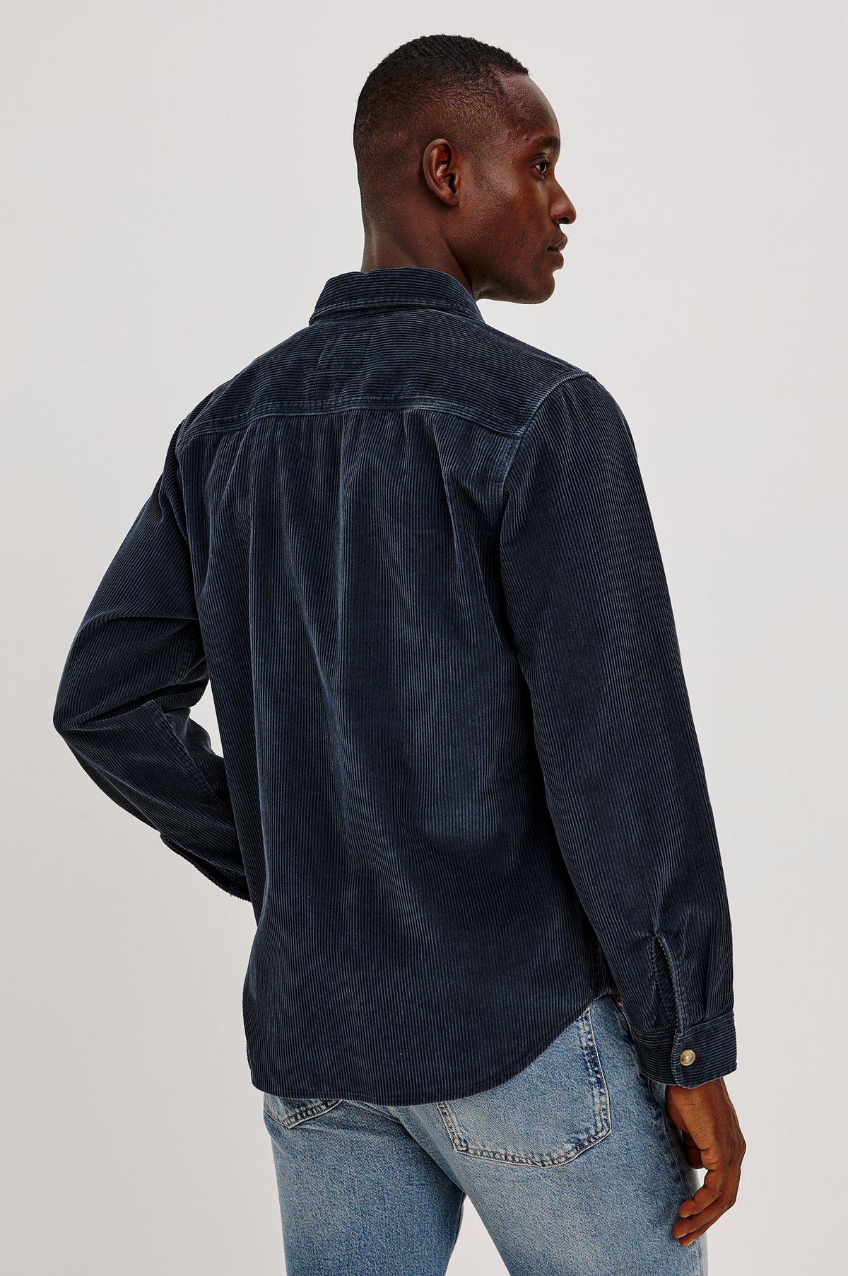 Graham Overshirt in Corduroy With Vintage Wash, Relaxed Fit, Collar, Chest Patch Pocket, and Front Buttons in Midnight Blue Colorway - Upper Body Back View Featured on Model