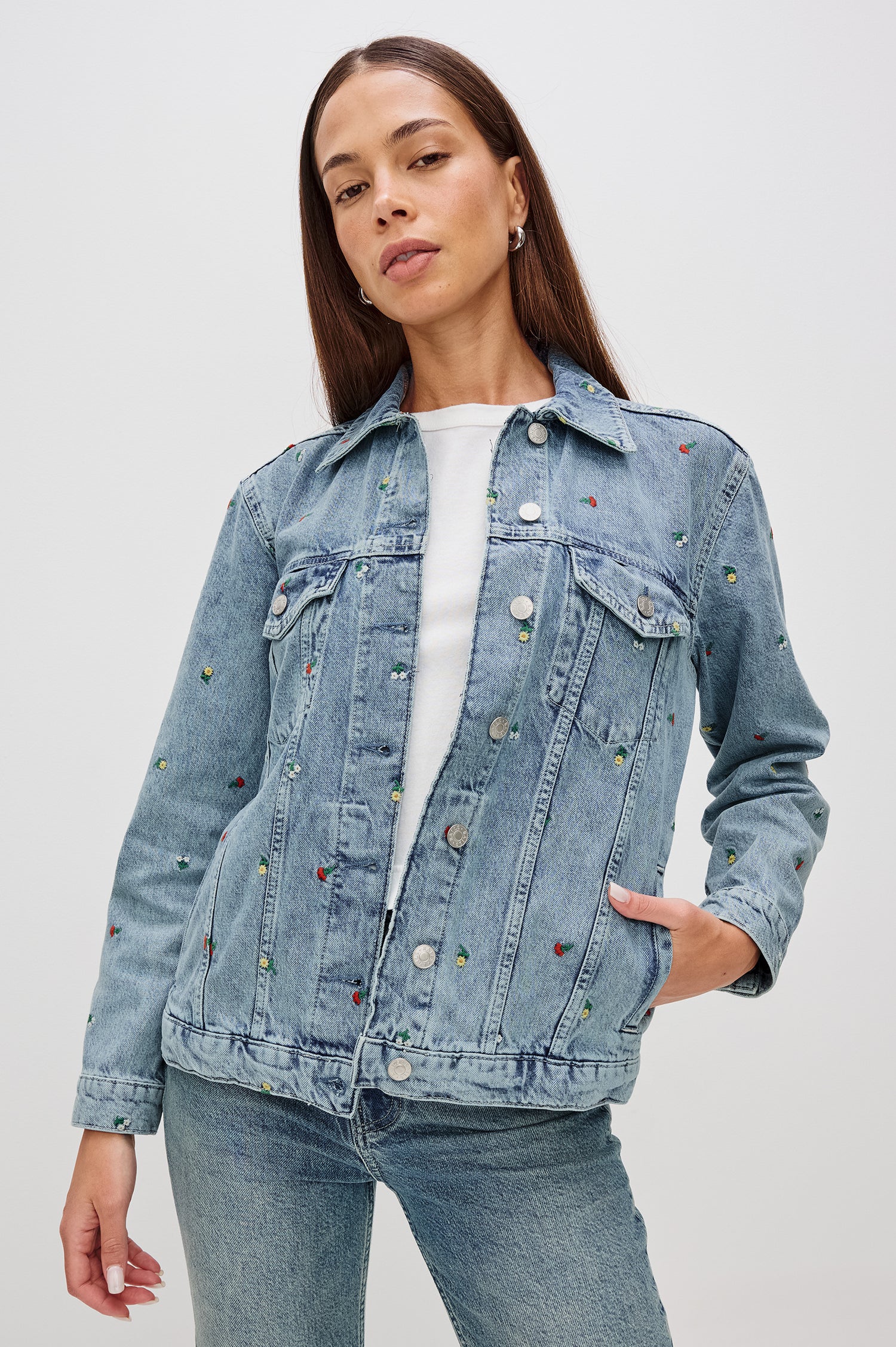 Grove Boyfriend Trucker Denim Jacket with Button Closure, Two Front Pockets, Two Chest Button Flap Pockets, Front Vertical Seams in Flower Field Colorway, with Embroidered Daisies in Yellow, Red and White - Front View Featured on Model  