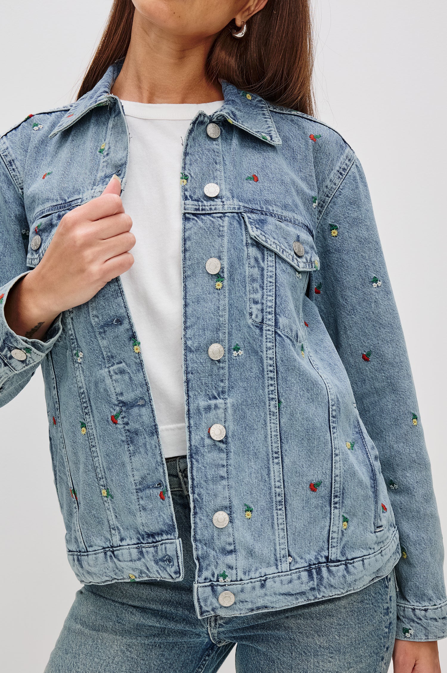 Grove Boyfriend Trucker Denim Jacket with Button Closure, Two Front Pockets, Two Chest Button Flap Pockets, Front Vertical Seams in Flower Field Colorway, with Embroidered Daisies in Yellow, Red and White - Front View Featured on Model  