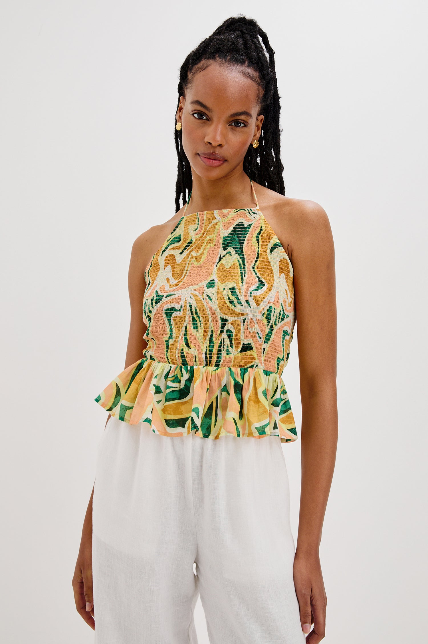 Gwendolyn Square Neck Halter Top with Smocked Body and a Ruffled Peplum Hem in Tulum Colorway. Front View Shown on Model. 