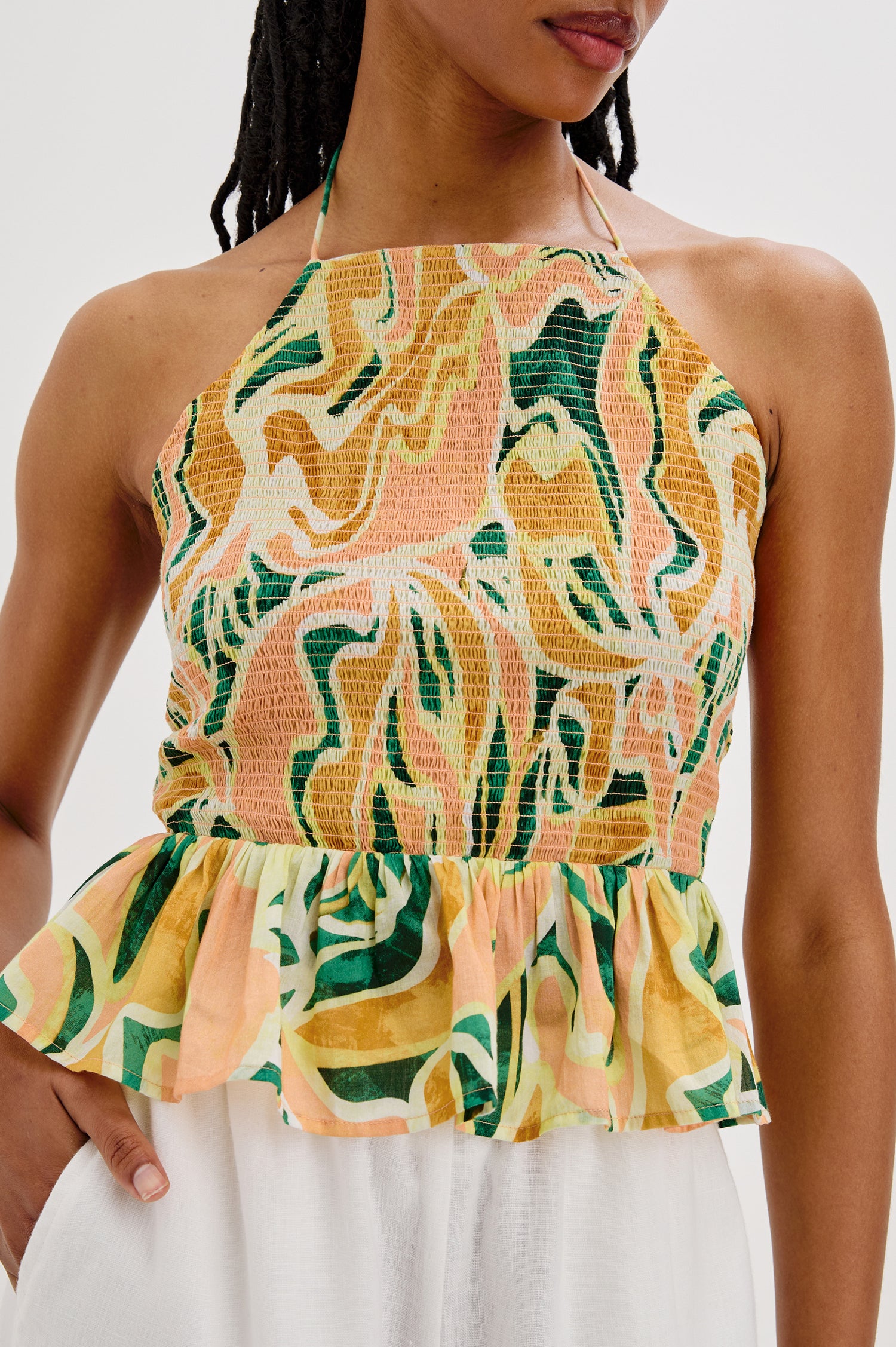 Gwendolyn Square Neck Halter Top with Smocked Body and a Ruffled Peplum Hem in Tulum Colorway. Front Detailed View Shown on Model. 