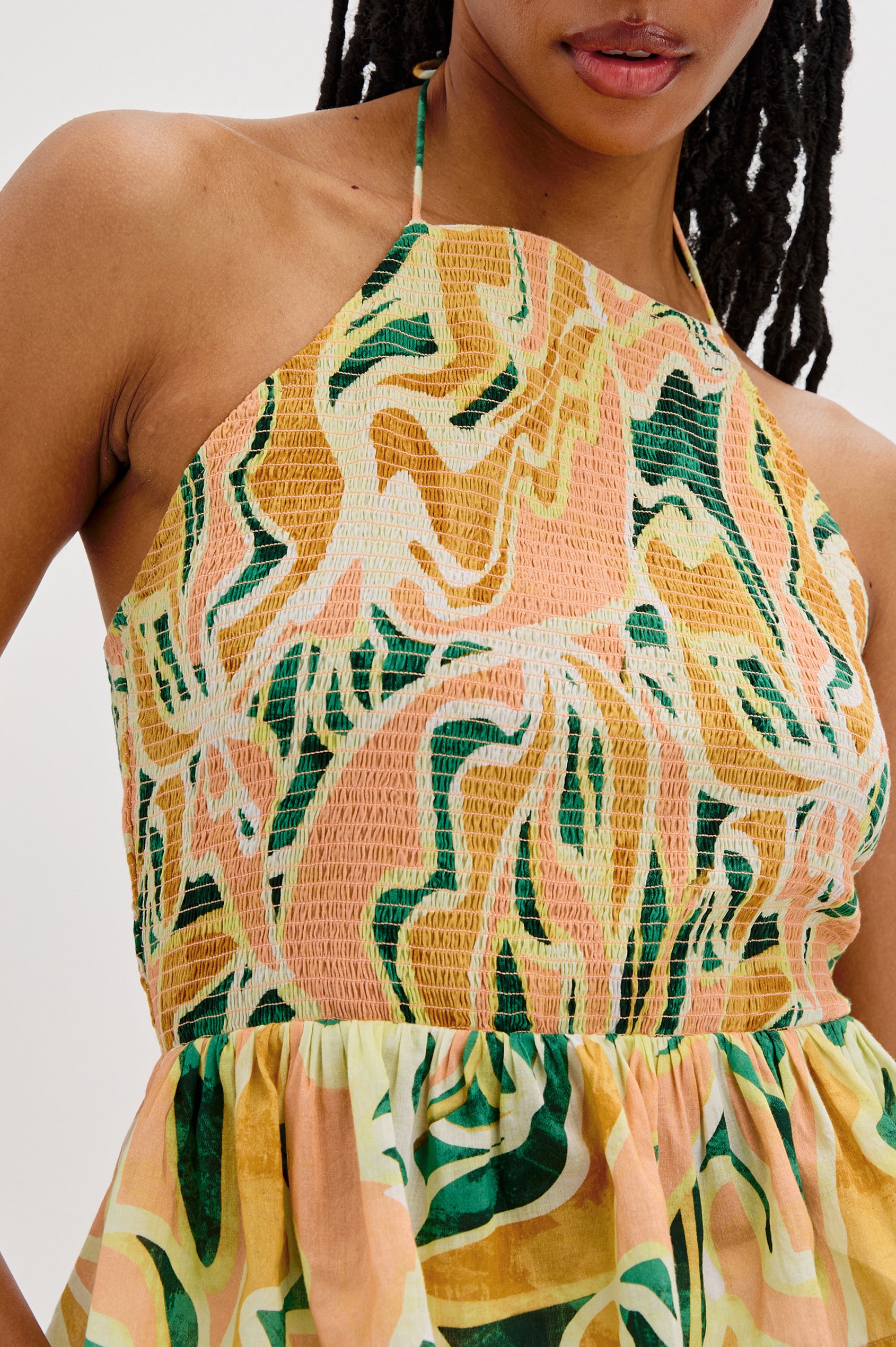 Gwendolyn Square Neck Halter Top with Smocked Body and a Ruffled Peplum Hem in Tulum Colorway. Front Detailed View Shown on Model. 