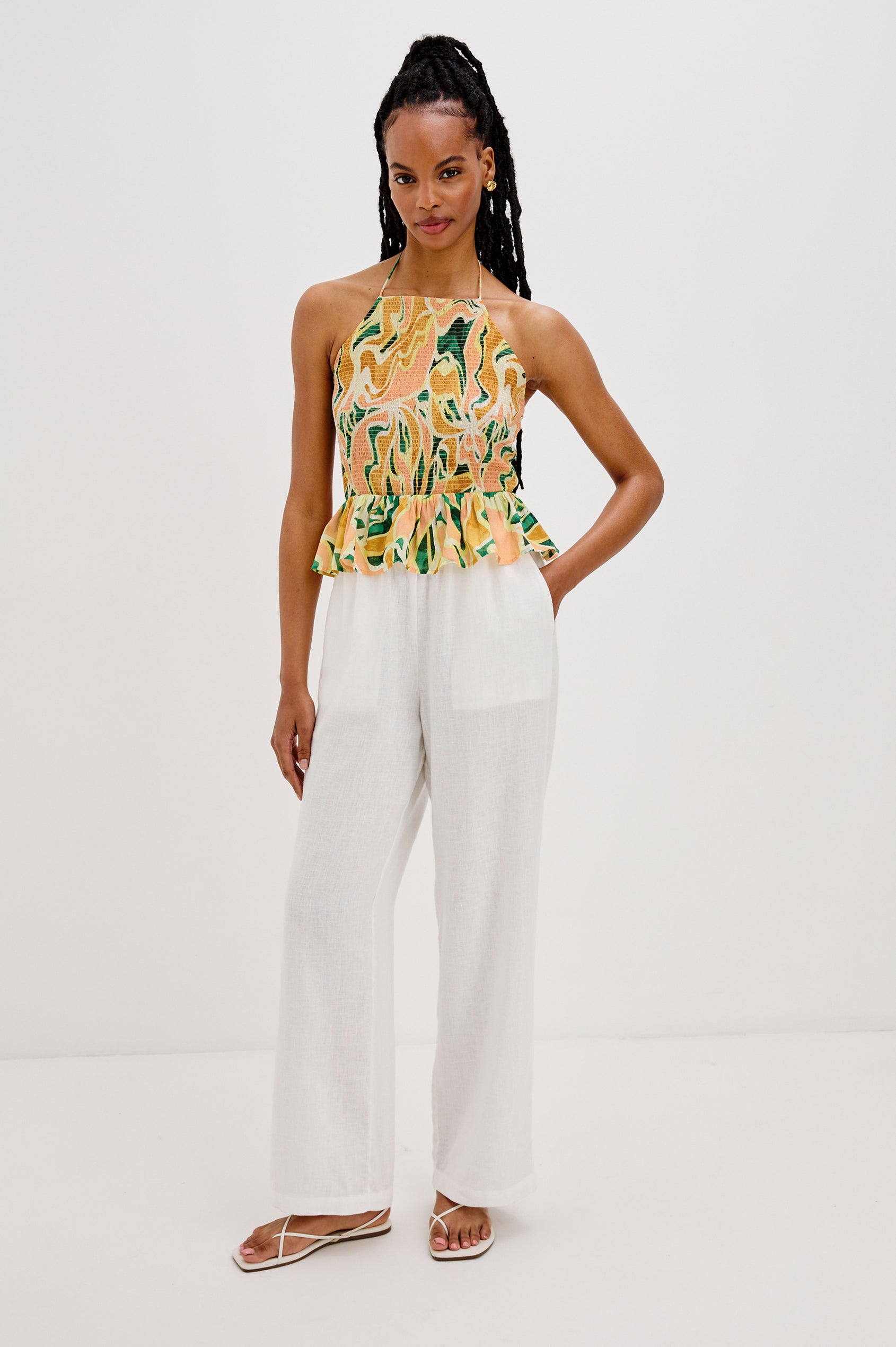 Gwendolyn Square Neck Halter Top with Smocked Body and a Ruffled Peplum Hem in Tulum Colorway. Full Body Front View Shown on Model. 