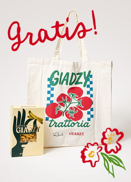 White tote bag with 'Gladzy Trattoria' design, box, and flowers on a light gray background