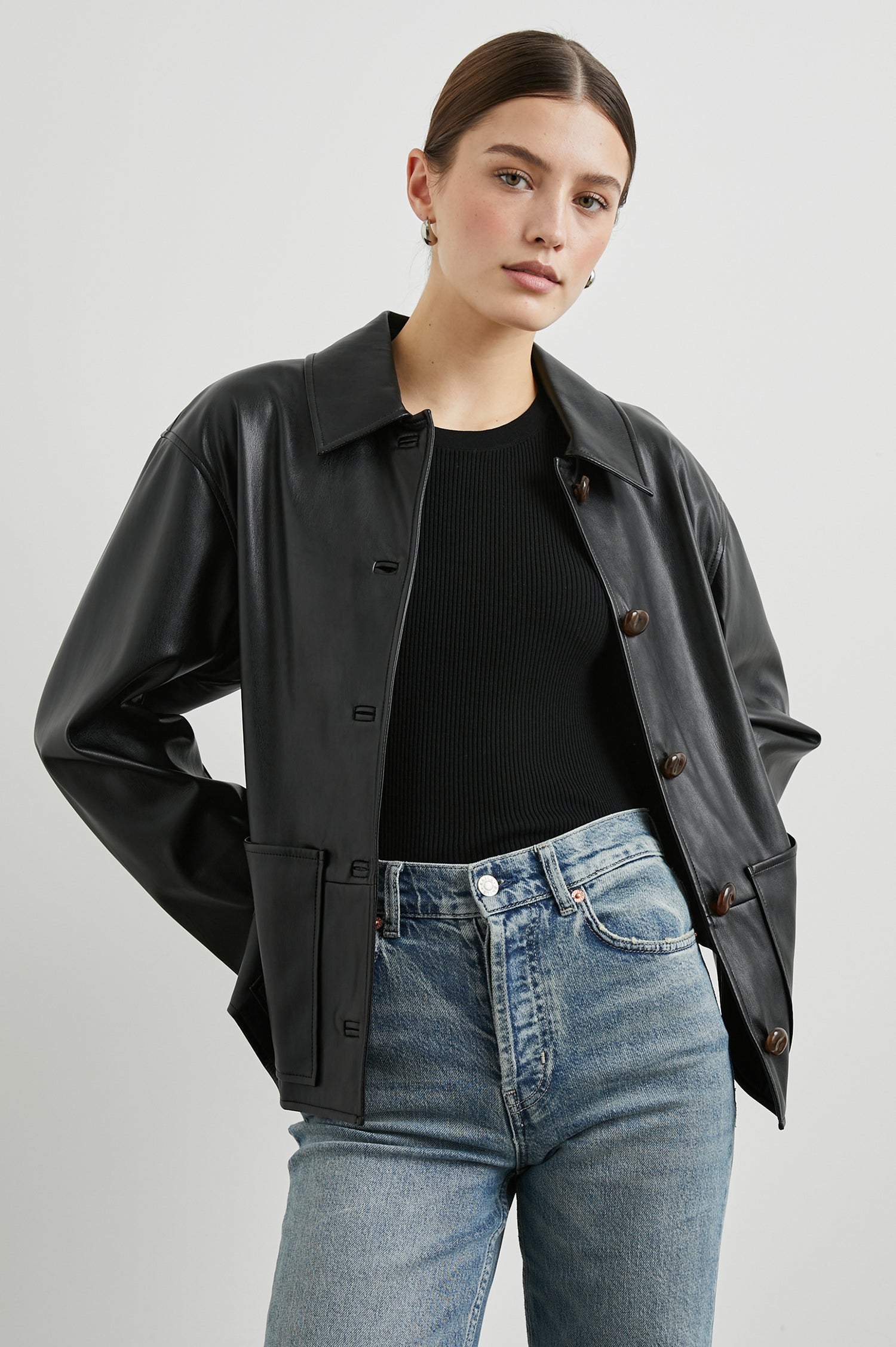 Haisley Faux Leather Jacket with Tortoiseshell Button Closure and Two Front Patch Pockets in Black Colorway - Front View Featured on Model 