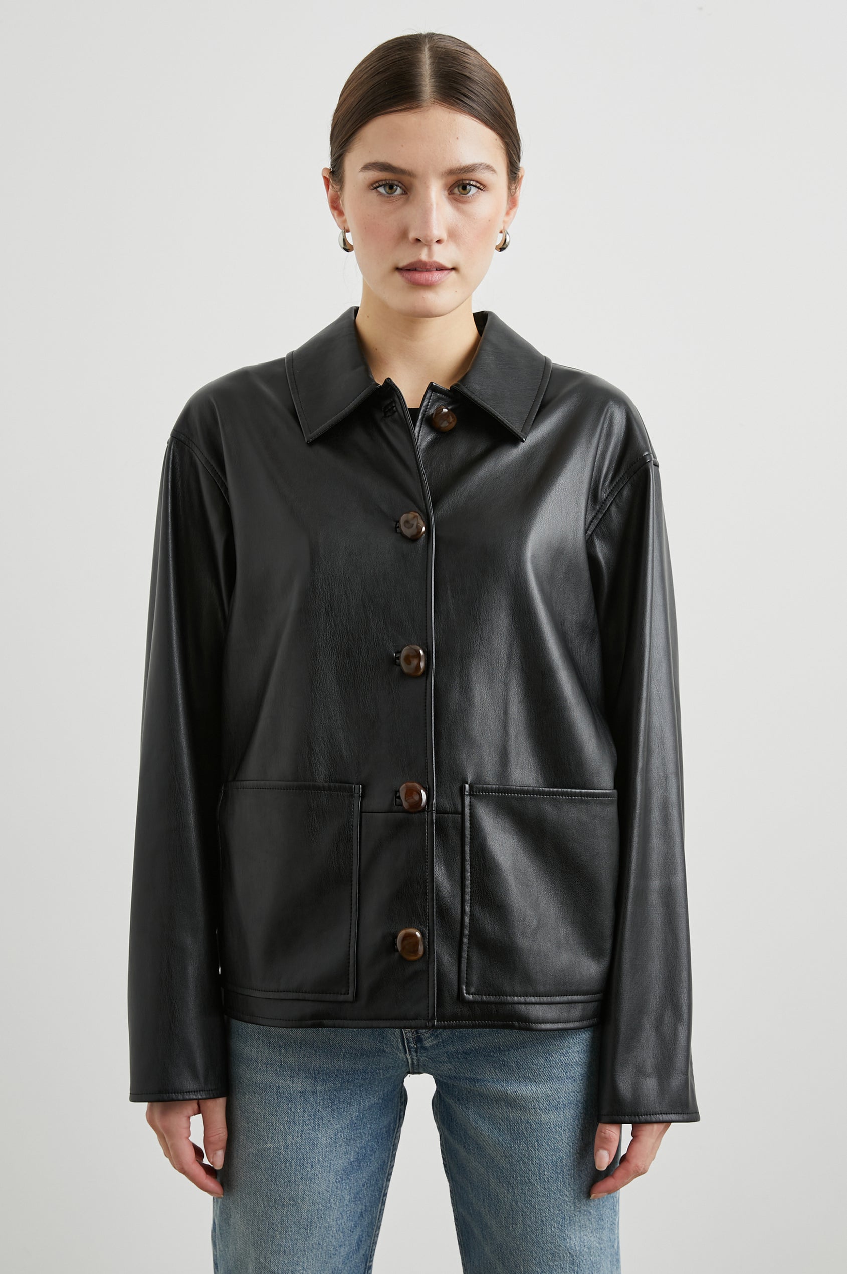 Haisley Faux Leather Jacket with Tortoiseshell Button Closure and Two Front Patch Pockets in Black Colorway - Front View Featured on Model 