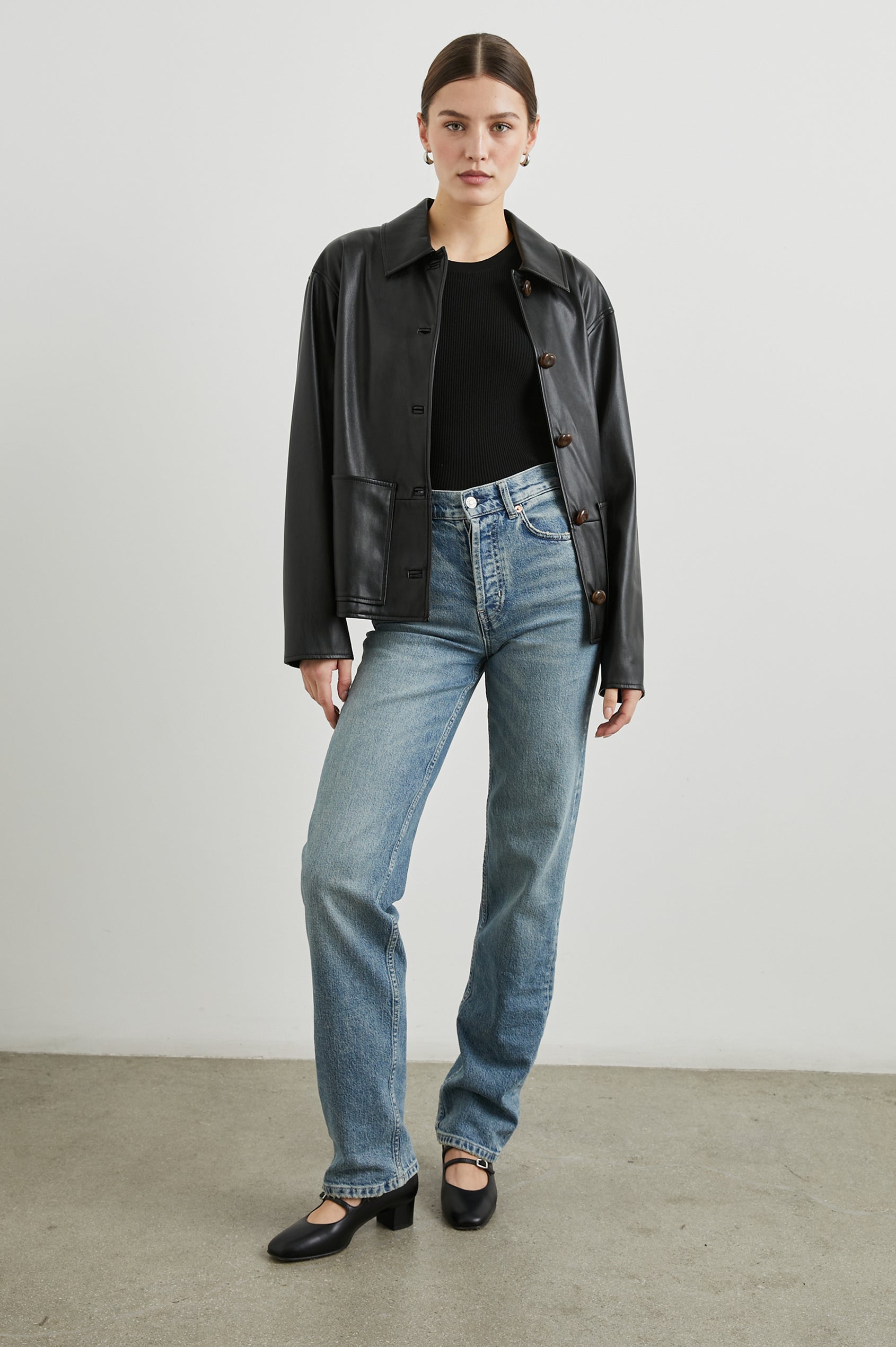 Haisley Faux Leather Jacket with Tortoiseshell Button Closure and Two Front Patch Pockets in Black Colorway - Front Full Body View Featured on Model 