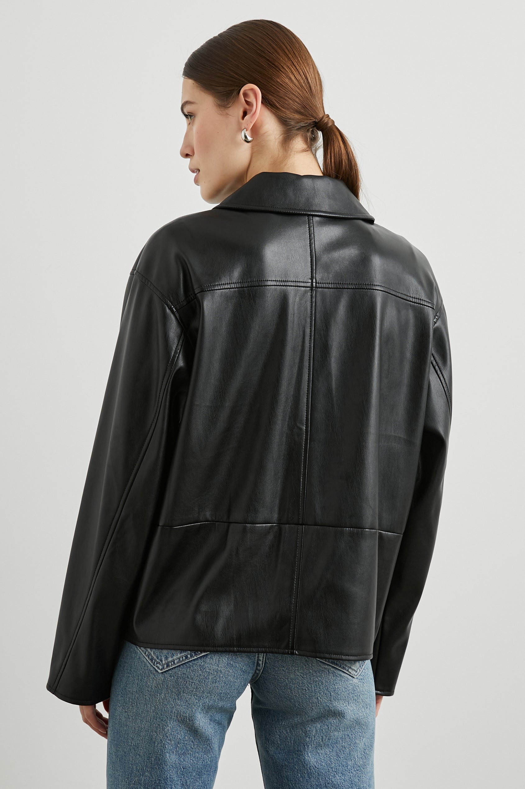 Haisley Faux Leather Jacket with Tortoiseshell Button Closure and Two Front Patch Pockets in Black Colorway - Back View Featured on Model 