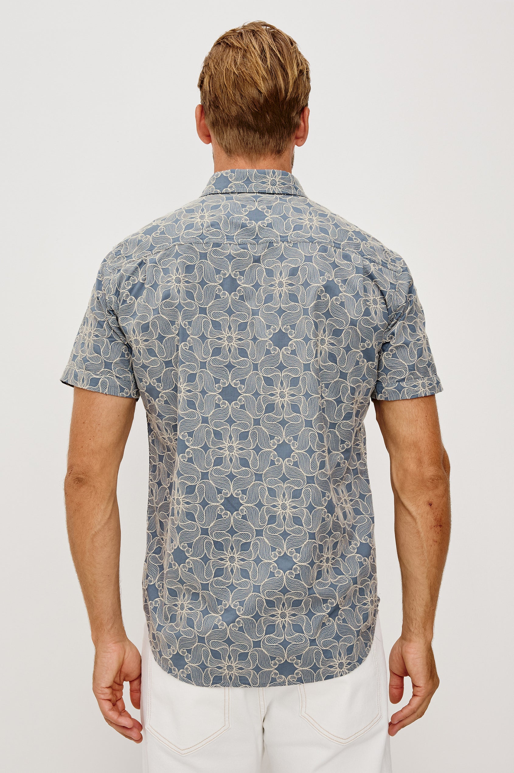Hale Button-Up Short Sleeve Shirt in Lightweight Cotton With Contrast Jute Floral Embroidery and a Classic Fit in Daisy Steel Colorway - Upper Body Back View Featured on Model