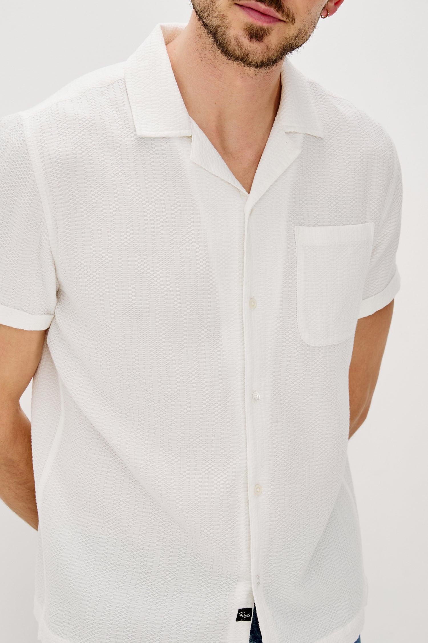 Haney Collared Button Front Shirt with Short Sleeves and a Chest Pocket in White Colorway. Front Detail View Shown on Model.