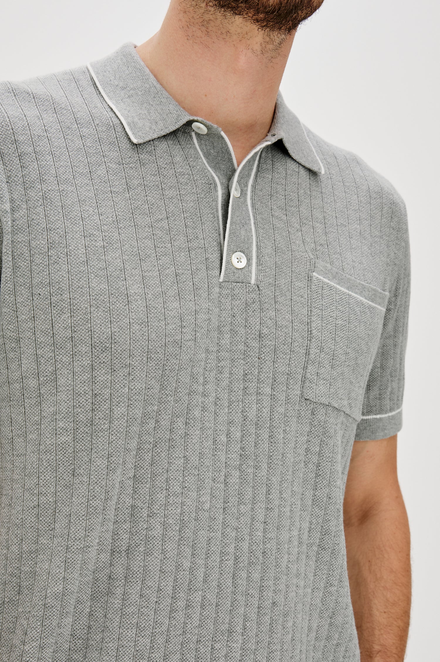 Hardy short sleeve cotton rib polo with chest pocket, two button placket and contrast stitching in Grey Melange - close up of details on model