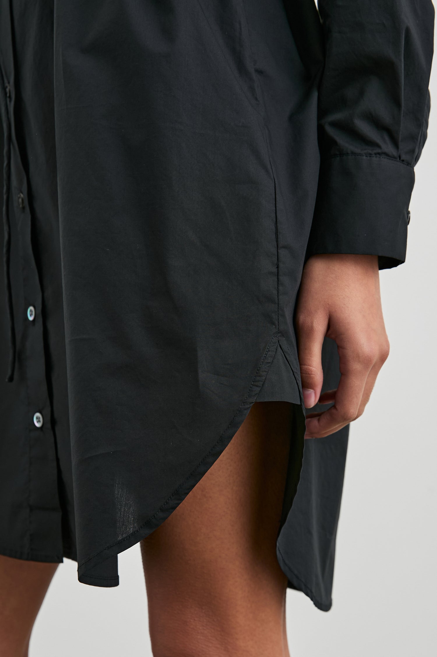 Harmony Long-Sleeve Mini Dress with Buttons Down the Front, Buttoned Cuffs, a Collar, Side Slits and a Tie at the Waist in Black Colorway - Front View Featured on Model