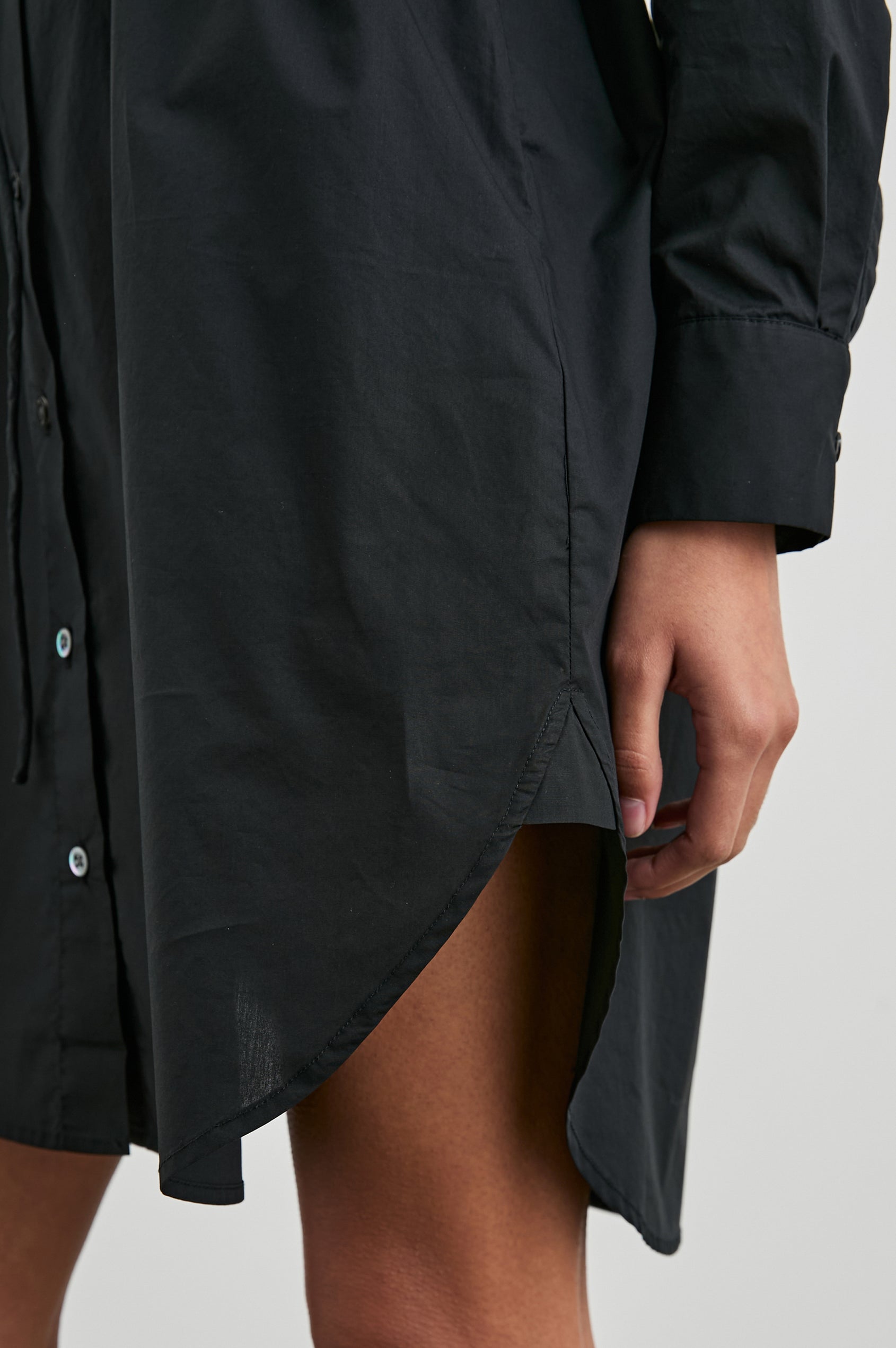 Harmony Long-Sleeve Mini Dress with Buttons Down the Front, Buttoned Cuffs, a Collar, Side Slits and a Tie at the Waist in Black Colorway - Front View Featured on Model