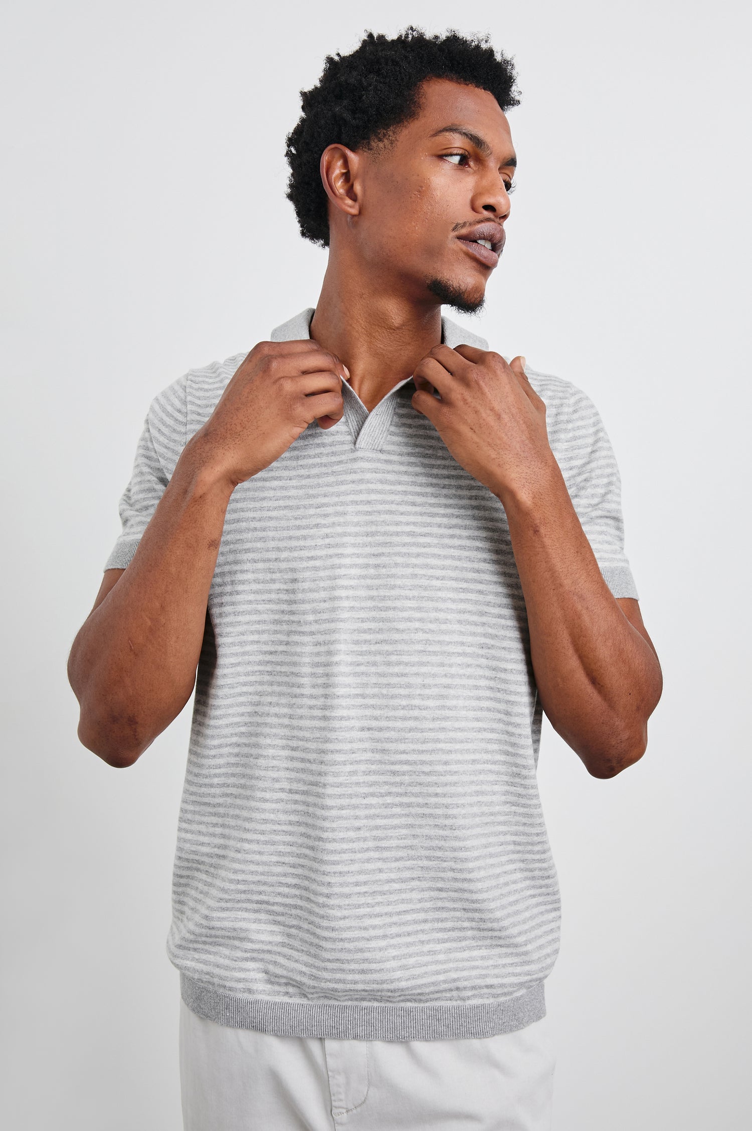 Hayden cotton short sleeve polo with collar, a short placket, and contrast trim in Heather Grey Stripe - front view on model