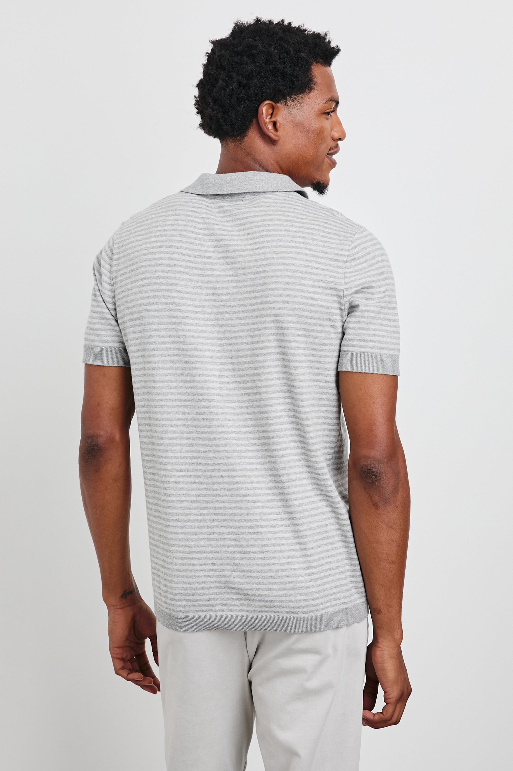 Hayden Short-Sleeve Polo Shirt with a Buttonless Placket in Heather Grey Stripe Colorway, horizontal stripes with vertical stripes on placket and trim - Back View Featured on Model