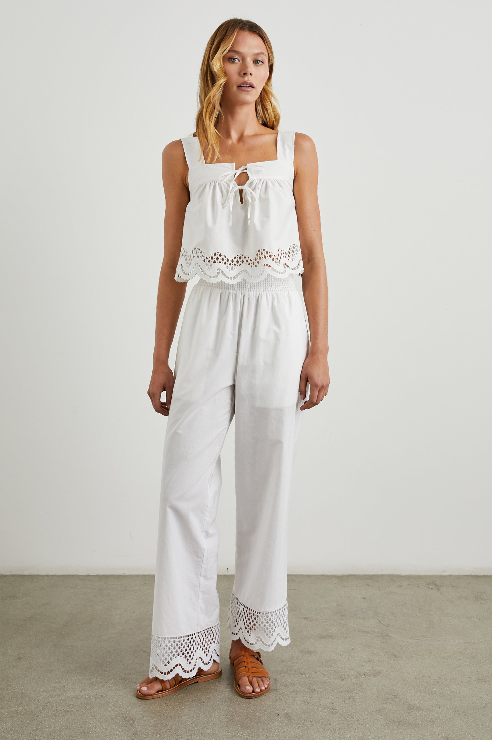 Henrik Pants with a Shirred Waist, Two Front Pockets and an Eyelet Design at the Hems in White Colorway - Front Full Body View Featured on Model 