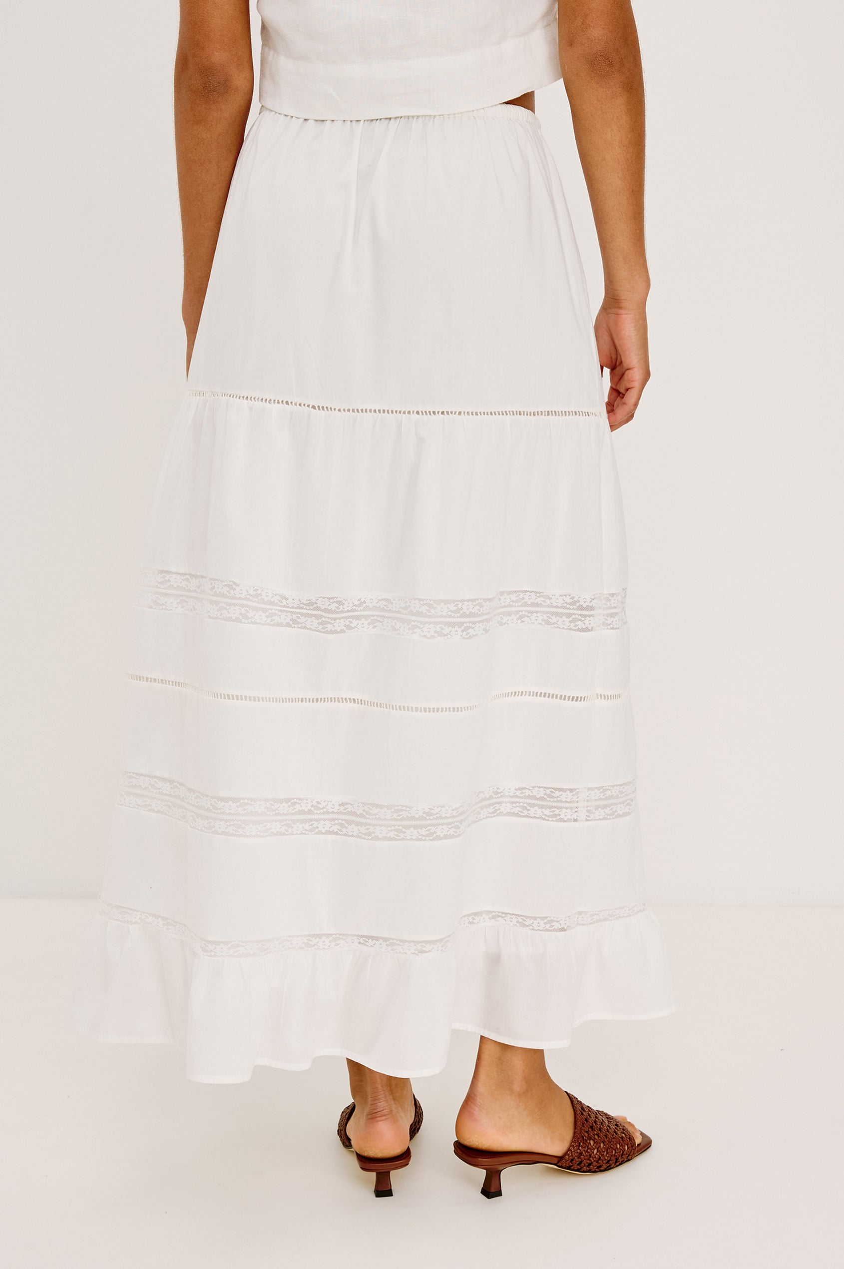 Hettie High-Waisted Maxi Skirt in Cotton Voile With Ladder Trim, Lace Insets, Self-Tie Waist, Relaxed Fit, and Fully Lined in White Colorway - Lower Body Back View Featured on Model