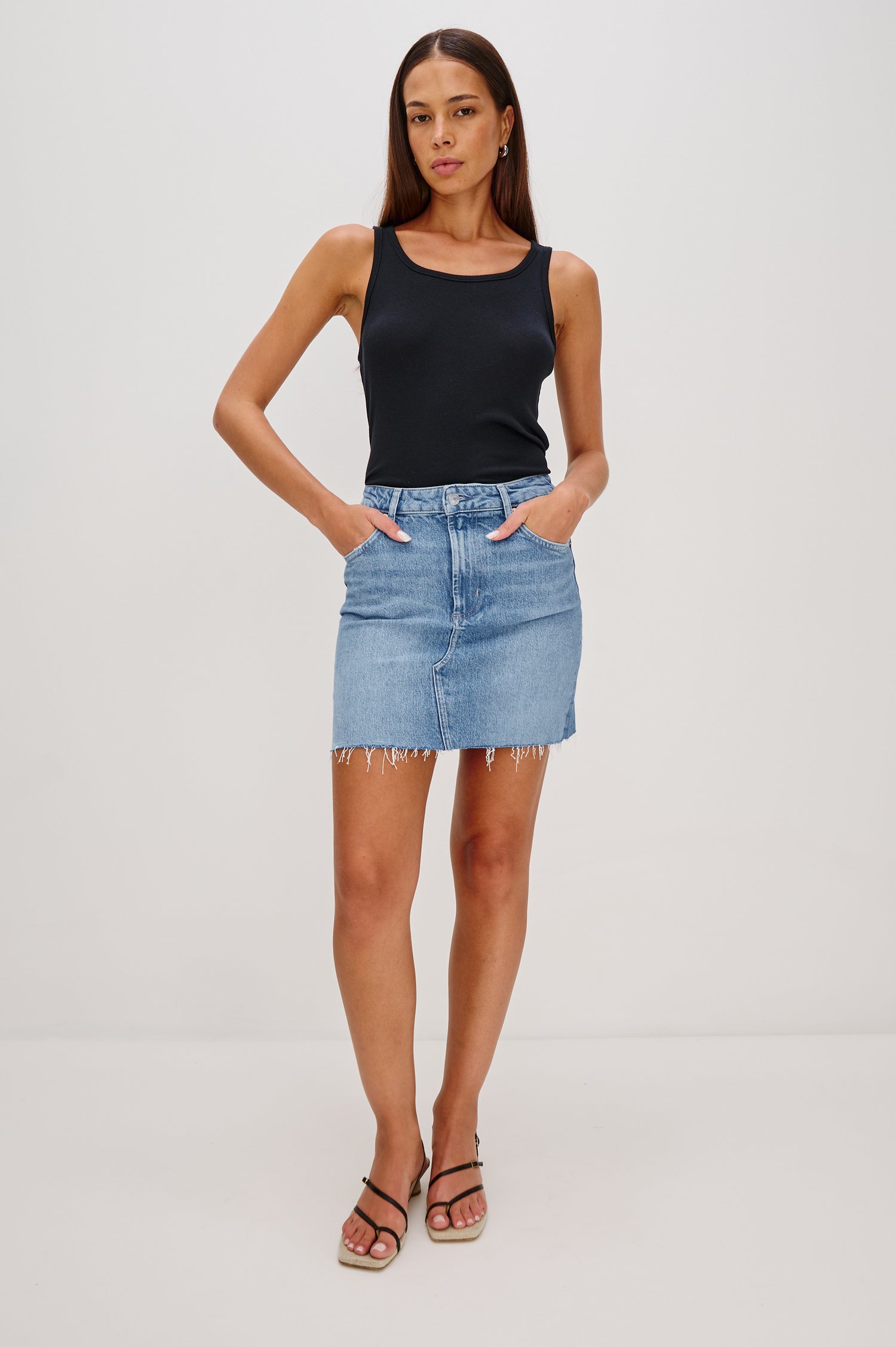 Highland 5-Pocket Denim Mini Skirt with Standard Zip + Button Fly, Raw Hem in Baja Blue Colorway. Full Body Front View Shown on Model.