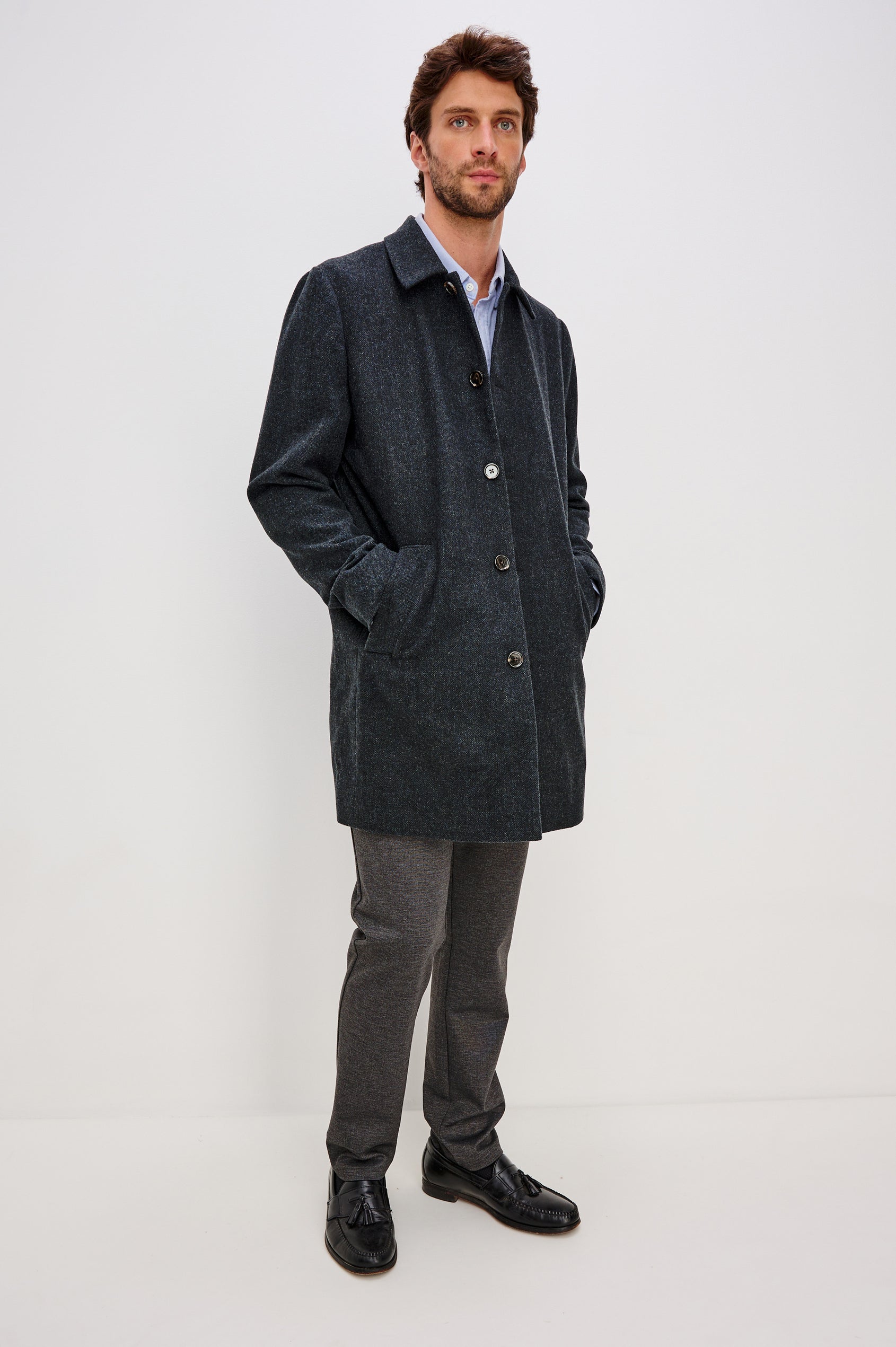 Hockney is a traditional top coat, wool-blended and lined with welt pockets, interior pockets on both sides (invisible zipper and welt), and a back vent, in Celestial Tweed Color. Front view featured on model.