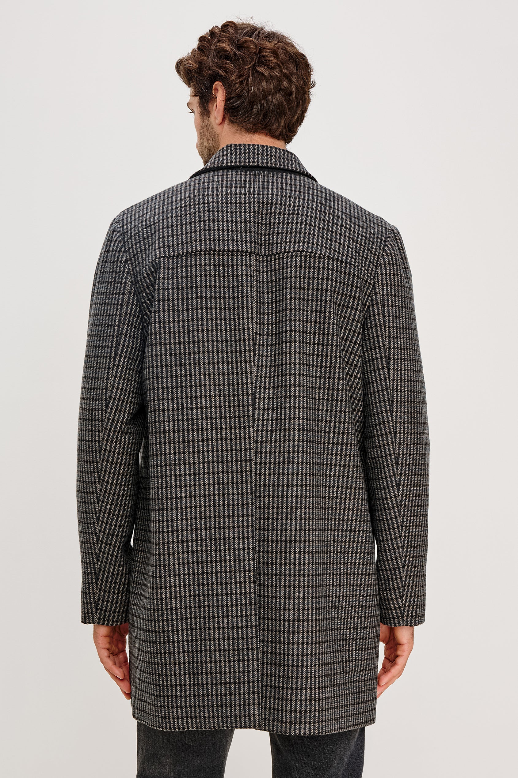 Hockney Mid-Thigh Length Overcoat with Button Closure, Two Front Pockets, and a Back Vent in Grey Check Plaid Colorway, a plaid in Grey, Black and Blue - Back View Featured on Model