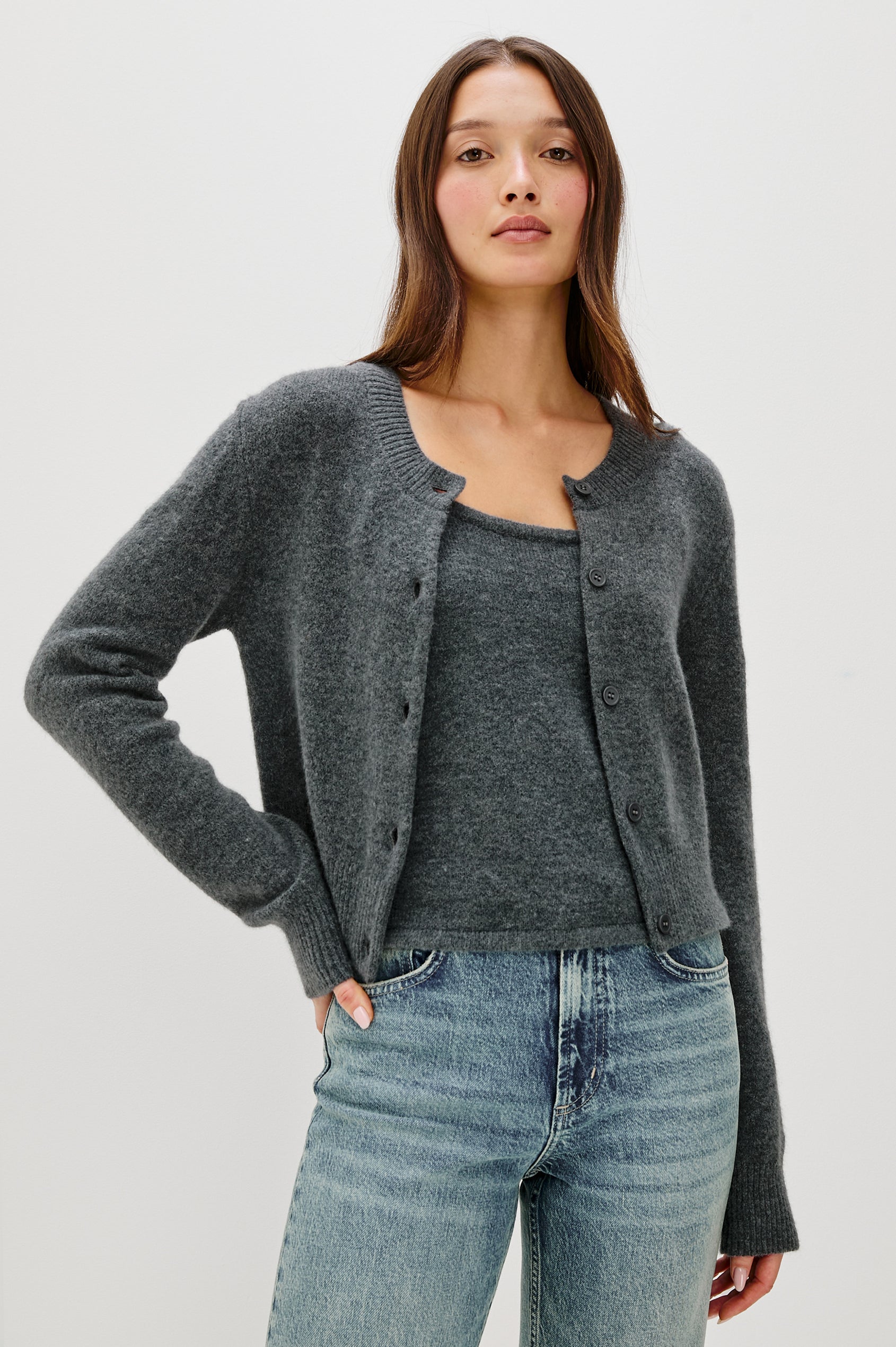 A knitted wool-blend tank top with a simple, classic fit in Charcoal Colorway. Front View featured on Model layered under matching sweater.
