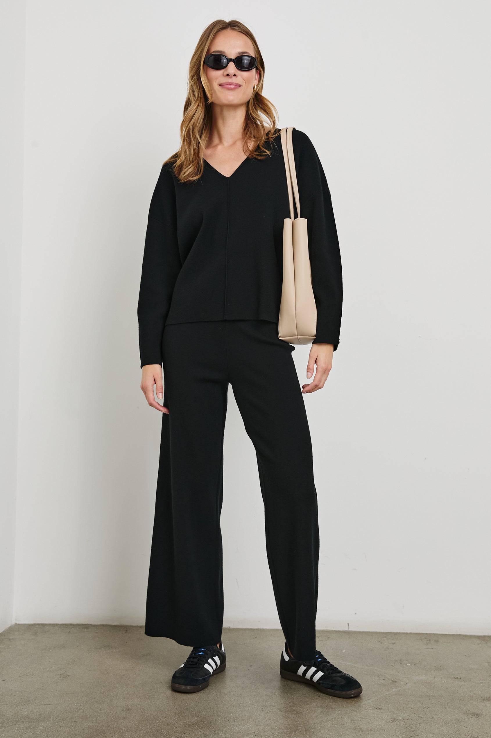 Hollyn Long-Sleeve Sweater with a V Neck and a Seam Down the Front Bodice and Sleeves in Black Colorway- Front Full Body View Featured on Model