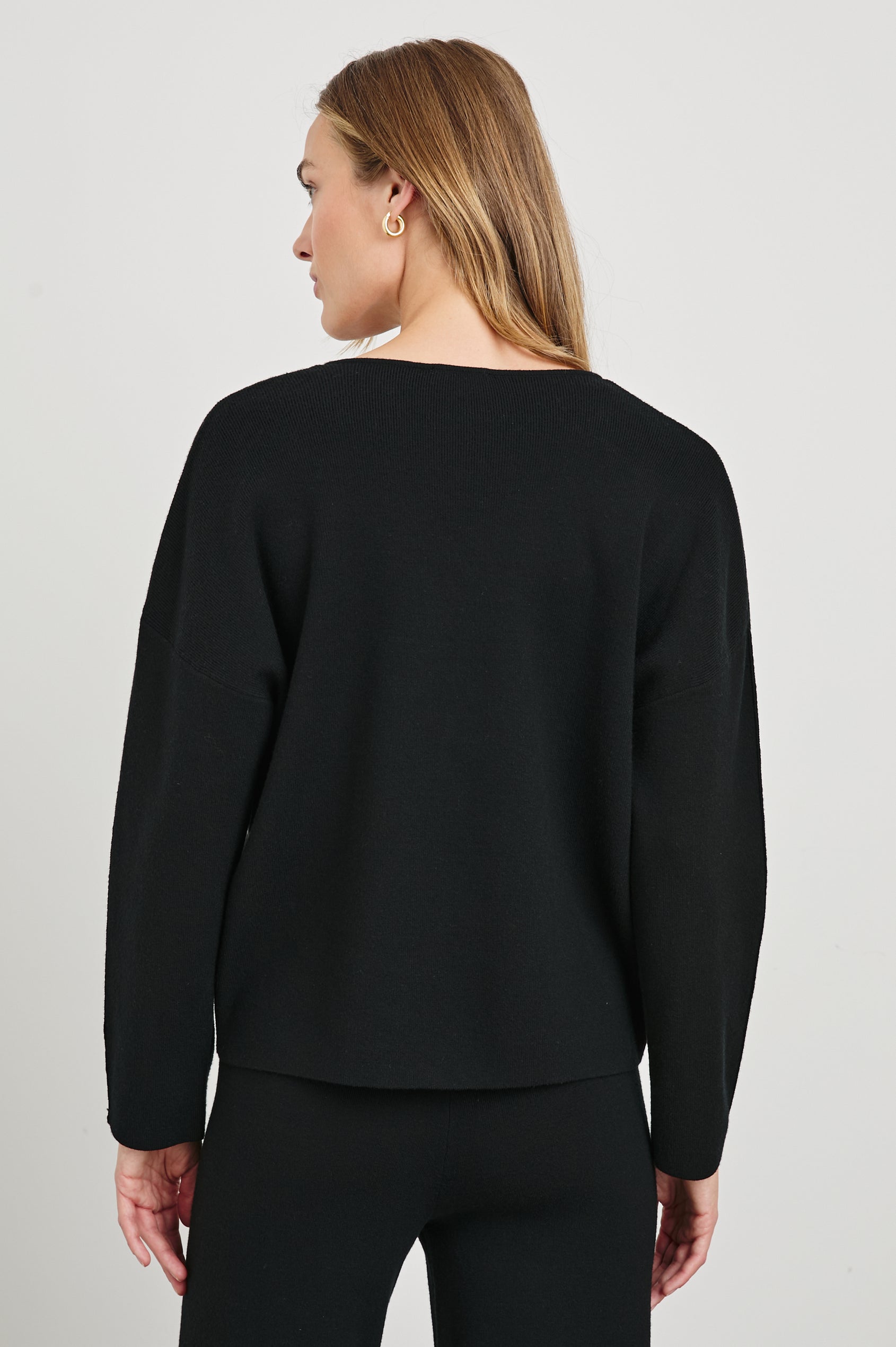 Hollyn Long-Sleeve Sweater with a V Neck and a Seam Down the Front Bodice and Sleeves in Black Colorway- Back View Featured on Model