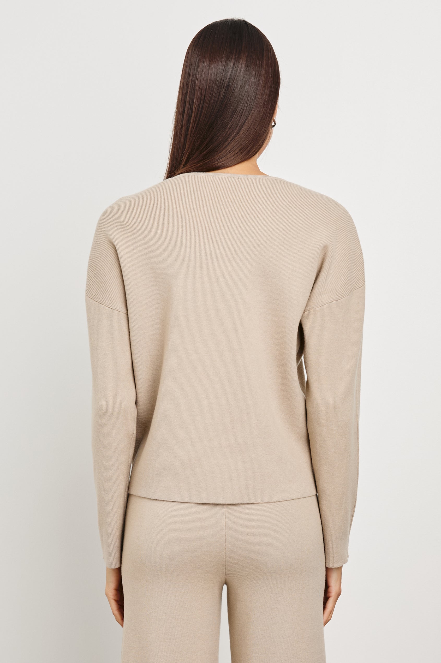 Hollyn Long-Sleeve, V Neck Sweater with a Vertical Seam Down the Front Bodice in Oatmeal Colorway - Back View Featured on Model 