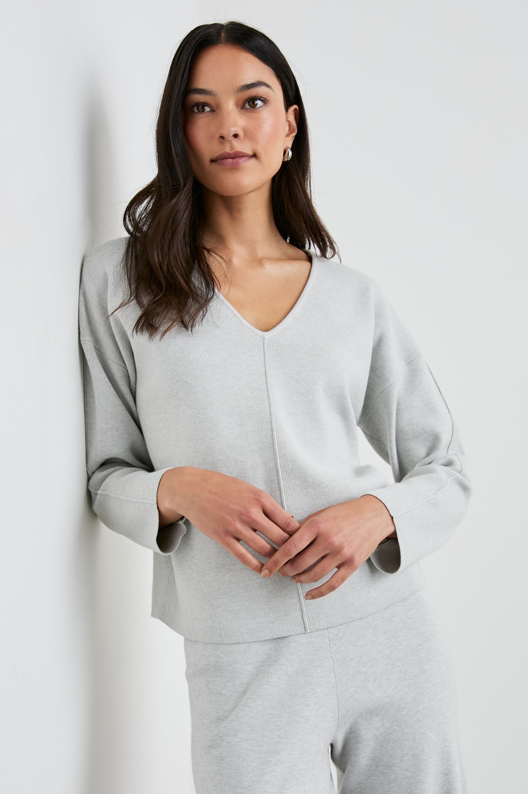 Hollyn Long-Sleeve Sweater with a V Neck and a Seam Down the Front Bodice and Sleeves in Light Heather Grey Colorway- Front View Featured on Model