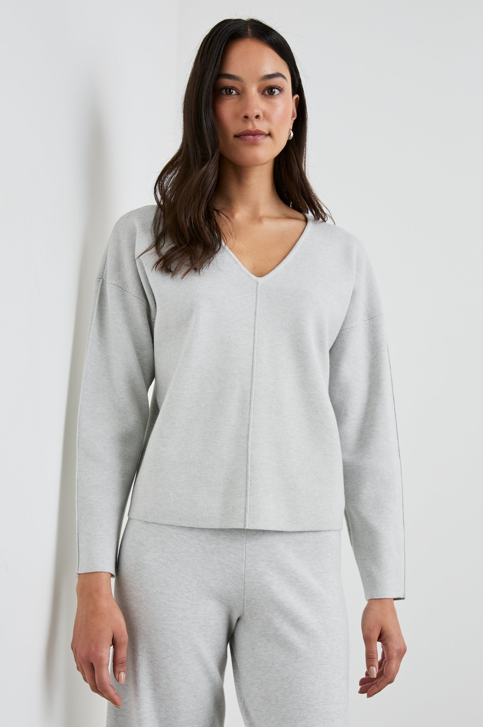 Hollyn Long-Sleeve Sweater with a V Neck and a Seam Down the Front Bodice and Sleeves in Light Heather Grey Colorway- Front View Featured on Model