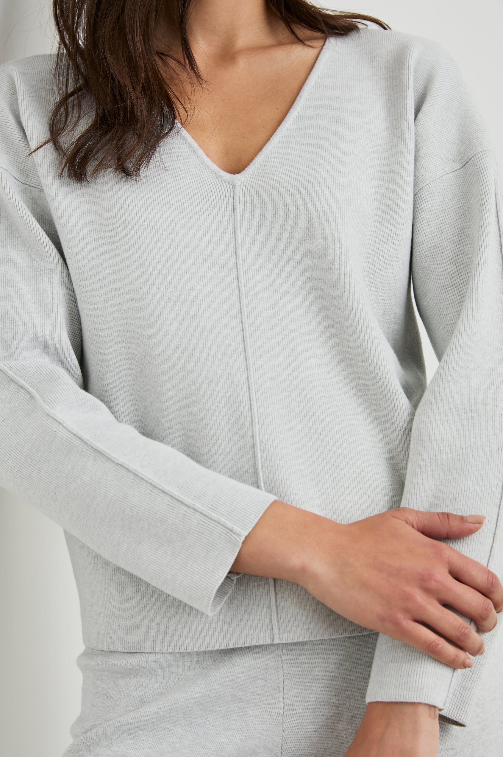 Hollyn Long-Sleeve Sweater with a V Neck and a Seam Down the Front Bodice and Sleeves in Light Heather Grey Colorway- Front View Featured on Model