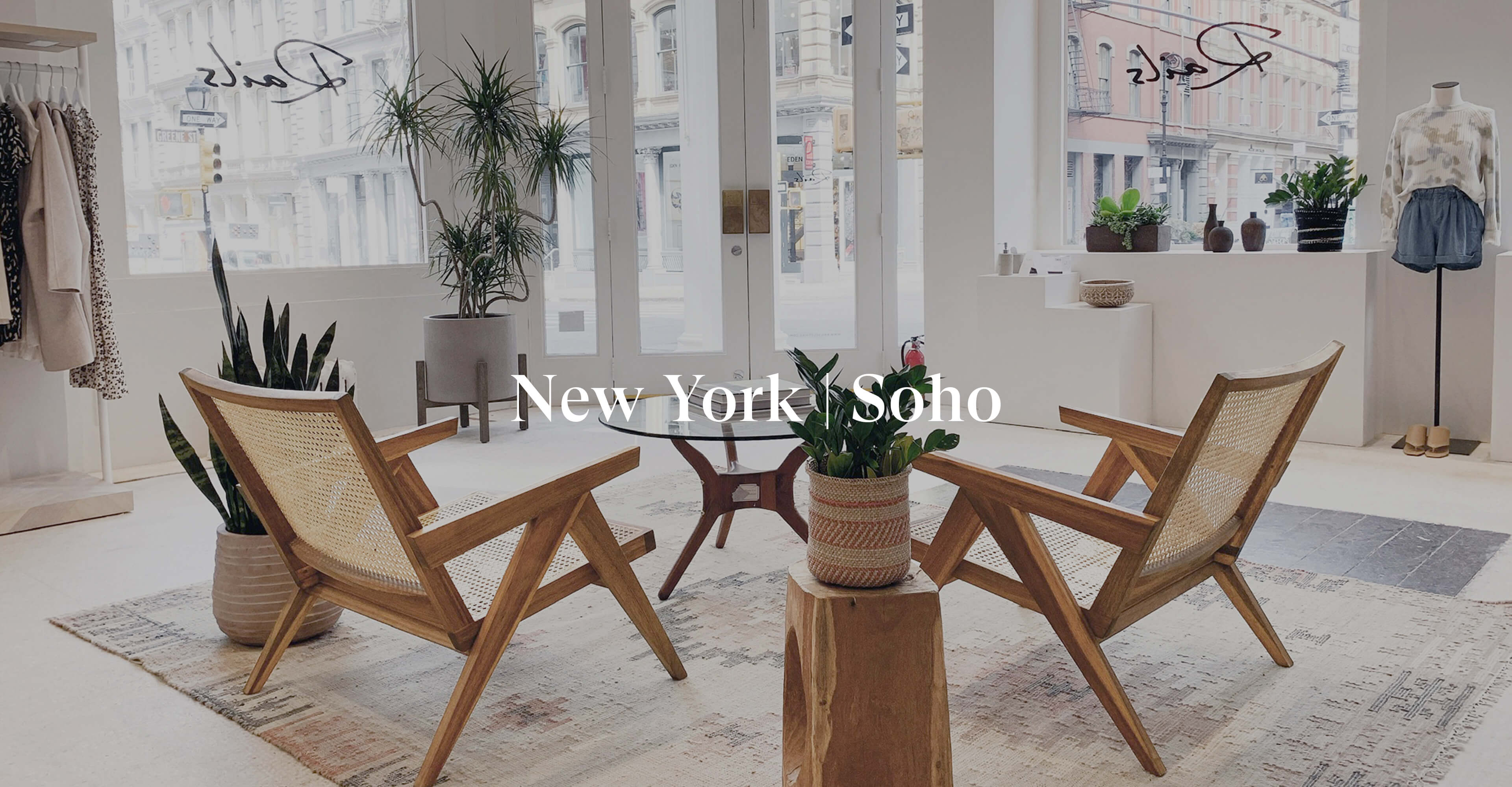 INSIDE OF SOHO STORE SHOWING THE ENTRANCE TO THE FRONT OF THE STORE AND TWO CHAIRS IN THE MIDDLE OF THE STORE