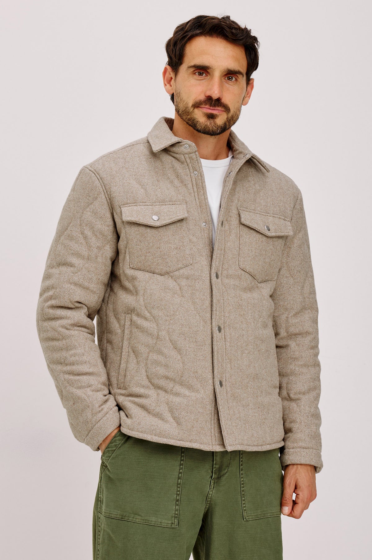 Humboldt Jacket in Wool Blend With Herringbone Texture, Channel Quilting, Filling, Snap Front, Collar, and Chest Flap Pockets in Stonefield Herringbone Colorway - Upper Body Front View Featured on Model.