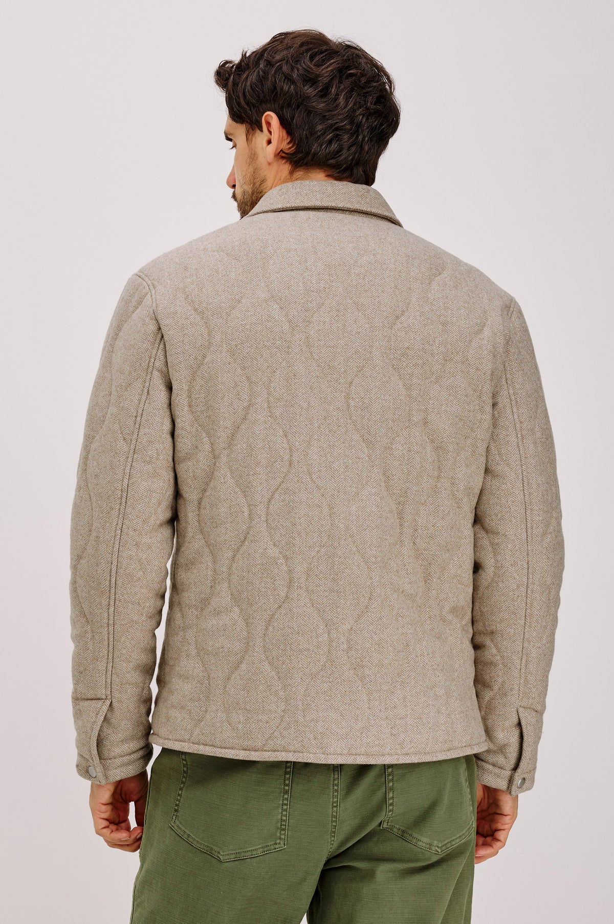 Humboldt Jacket in Wool Blend With Herringbone Texture, Channel Quilting, Filling, Snap Front, Collar, and Chest Flap Pockets in Stonefield Herringbone Colorway - Upper Body Back View Featured on Model.