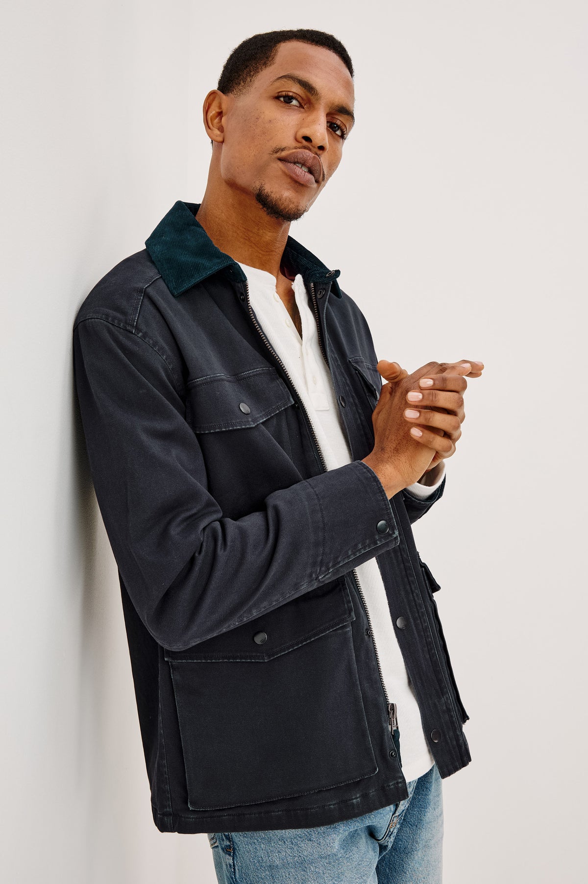 Huntly Jacket in Twill With Plaid Lining, Corduroy Collar, Storm Flap Snap-and-Zip, Four Front Snap Flap Pockets, and Long Sleeves in Creosote Colorway - Upper Body Side View Featured on Model