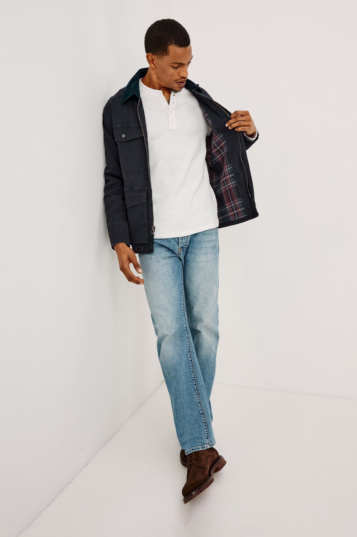 Huntly Jacket in Twill With Plaid Lining, Corduroy Collar, Storm Flap Snap-and-Zip, Four Front Snap Flap Pockets, and Long Sleeves in Creosote Colorway - Full Body Front View Featured on Model