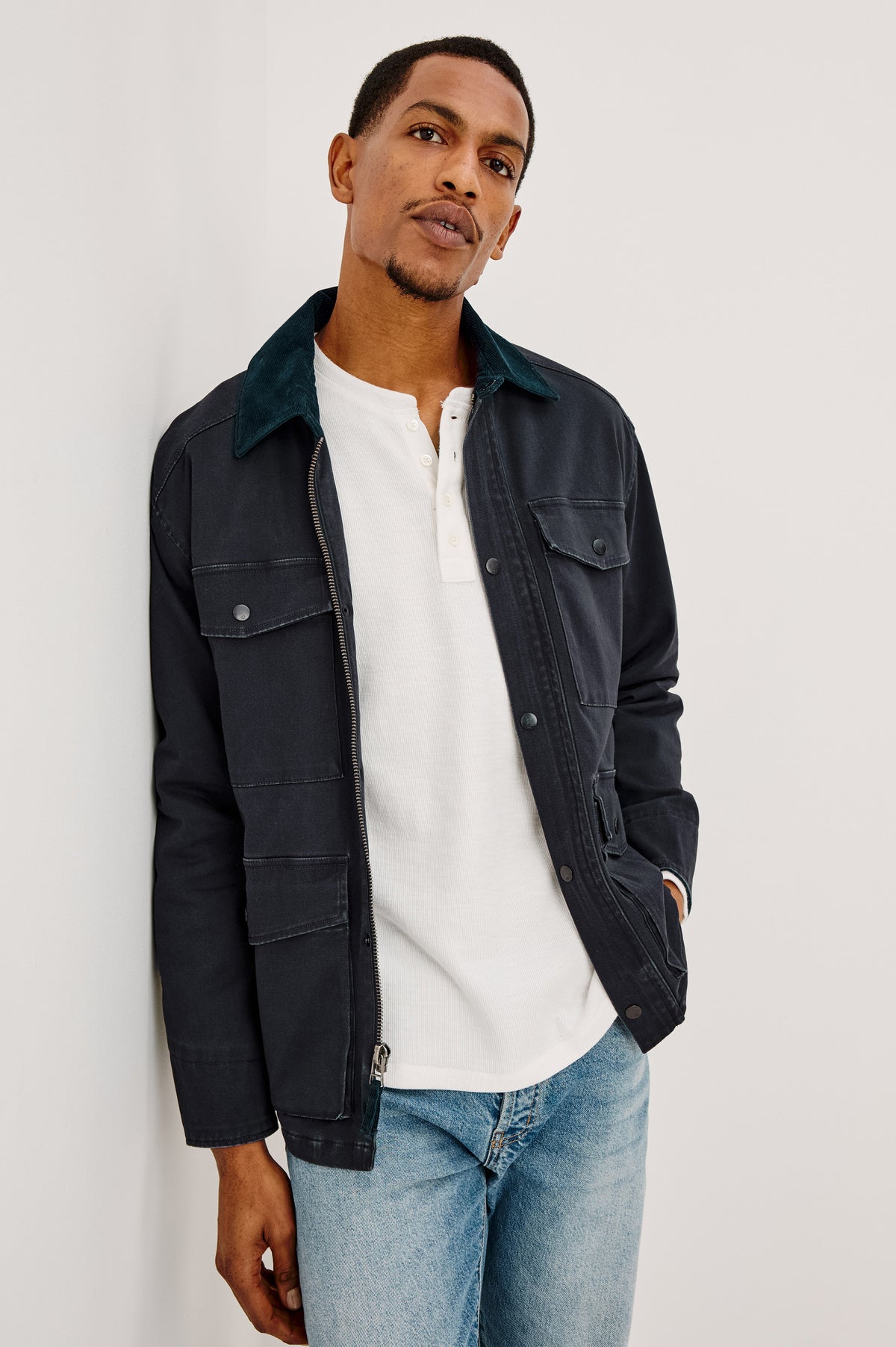 Huntly Jacket in Twill With Plaid Lining, Corduroy Collar, Storm Flap Snap-and-Zip, Four Front Snap Flap Pockets, and Long Sleeves in Creosote Colorway - Upper Body Front View Featured on Model
