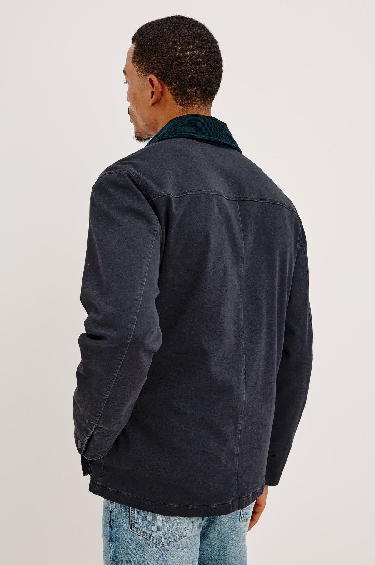 Huntly Jacket in Twill With Plaid Lining, Corduroy Collar, Storm Flap Snap-and-Zip, Four Front Snap Flap Pockets, and Long Sleeves in Creosote Colorway - Upper Body Back View Featured on Model