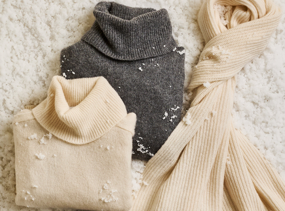 EDITORIAL IMAGE OF TWO SWEATERS AND A SCARF