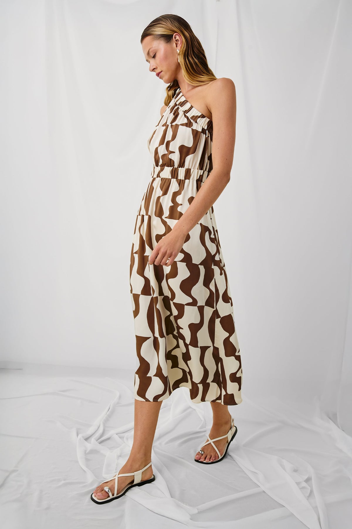 India is a one-shoulder midi dress with elastic at nechline and waist in Copper Noto print, full body back view featured on model.