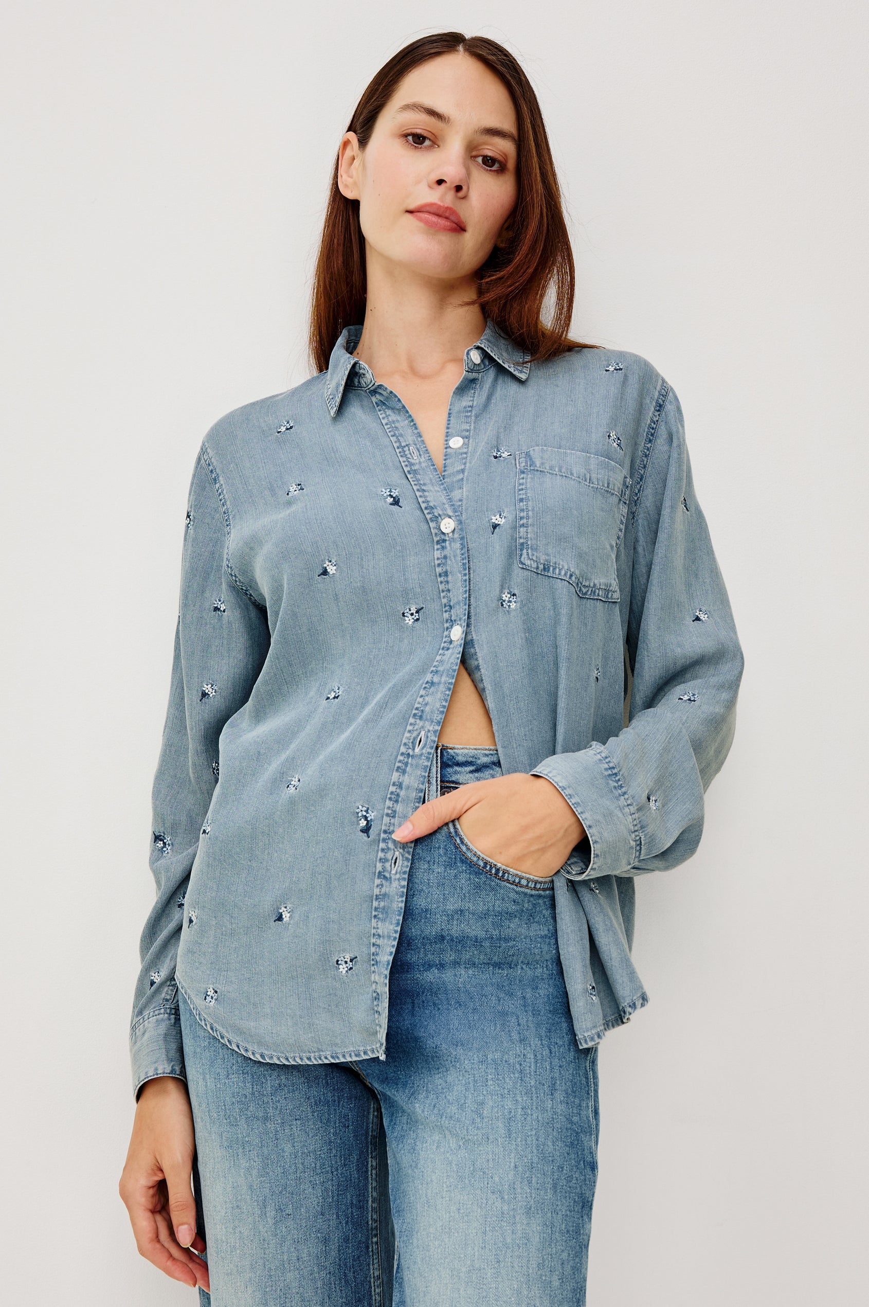 Ingrid Button-Up Collared Shirt in TENCEL™Denim With Vintage-Inspired Wash, Floral Embroidery, a Chest Patch Pocket, and Long Sleeves in Blossoms Colorway - Upper Body Front View Featured on Model