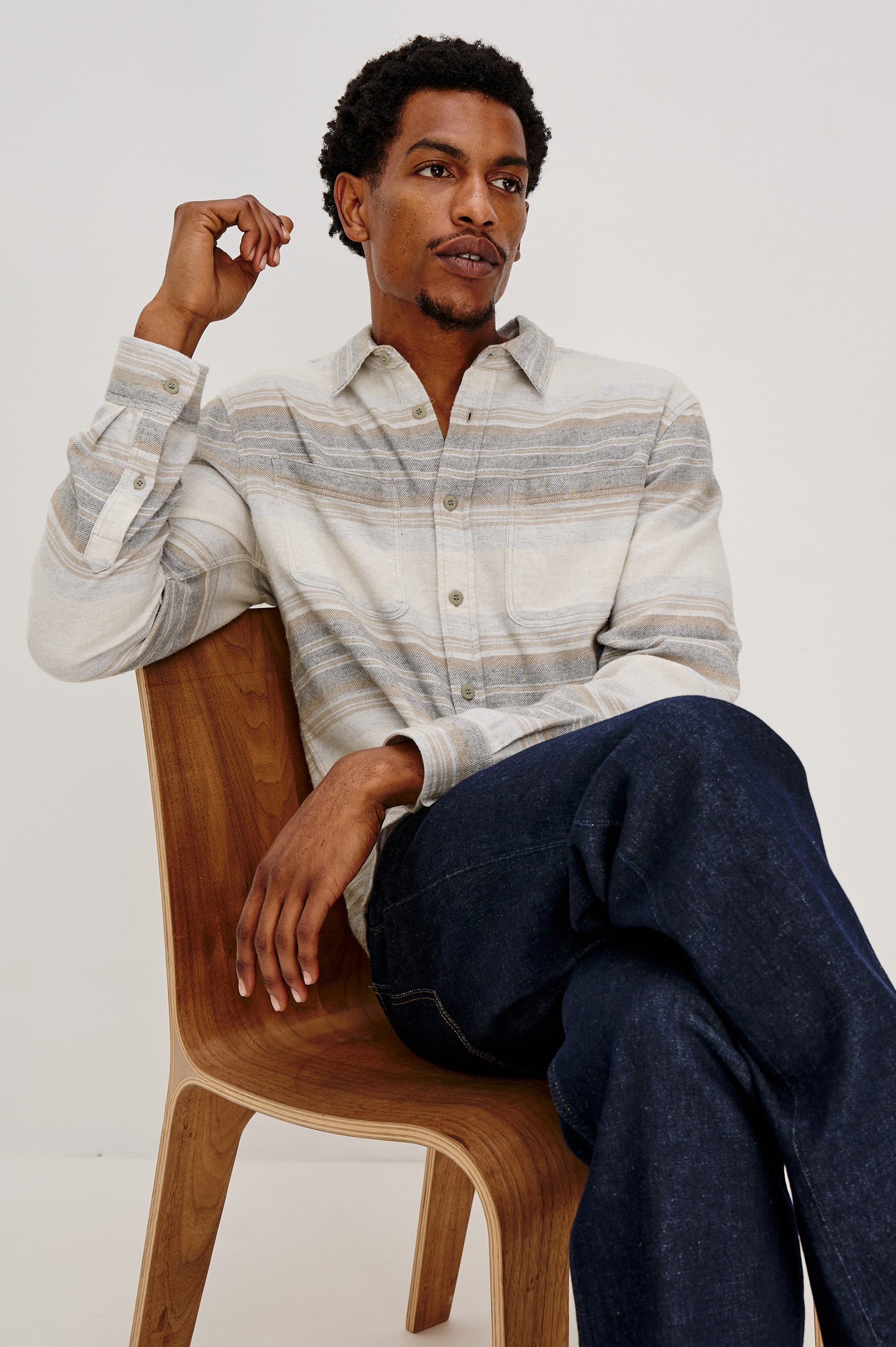 Ivan button front collared shirt with long sleeves and two chest pockets in horizontal stripe - lunar rock stripe colorway. Front View of Model Sitting Shown.
